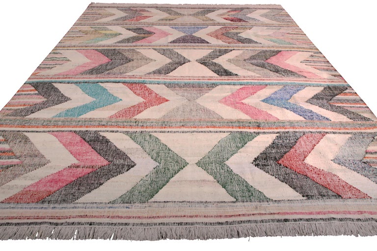 This contemporary Kilim represents a selection of distinct new patterns joining Rug & Kilim’s new and modern collection, uniquely handwoven from the yarns of Classic textiles and Kilims lending to the eccentric variations in color and bold pattern