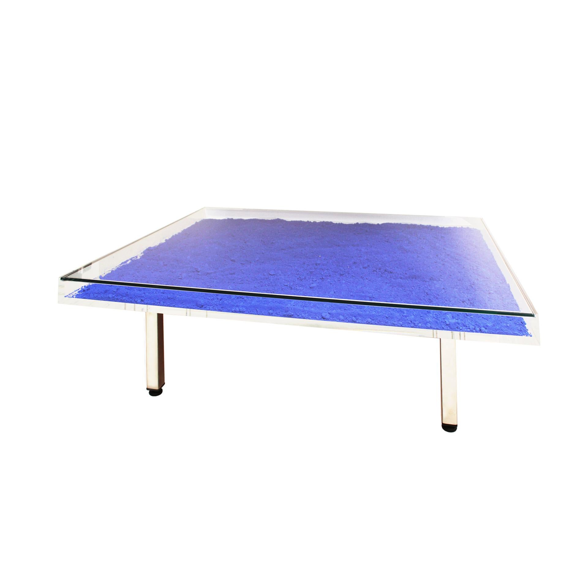 “IKB” model coffee table designed by the French artist Yves Klein (1928-1962). Table composed of a box made of perplex with a glass top lid inside which Klein blue pigments are distributed in powder format. Legs made of stainless steel. This piece