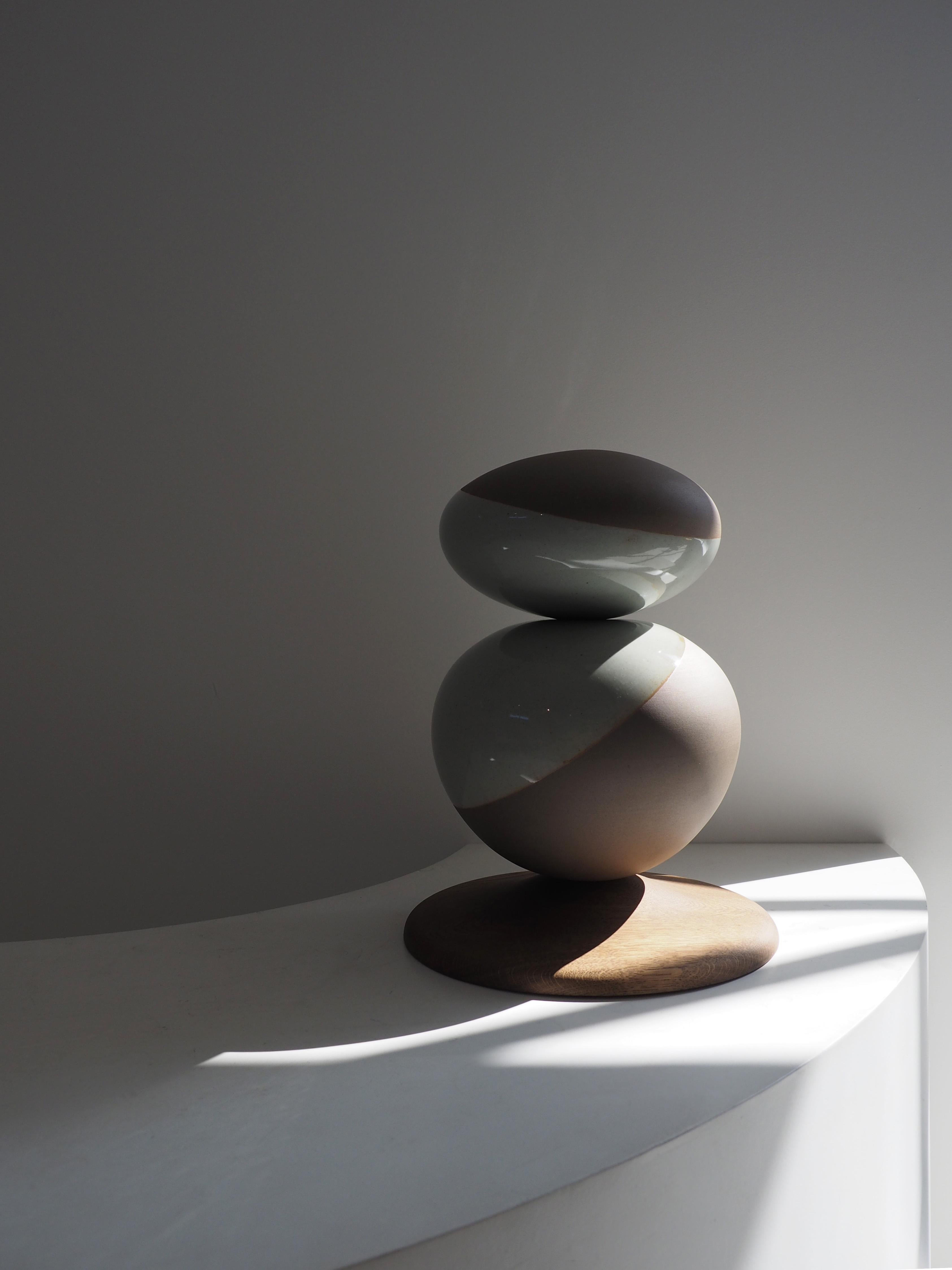 Stack Sculpture Pair by Soo Joo is a stack sculpture made in Korean Ceramic. It is a timeless form, reminiscent of a pair of perfectly balanced river stones. The stack sculpture series is created with traditional Korean aesthetics in mind, using