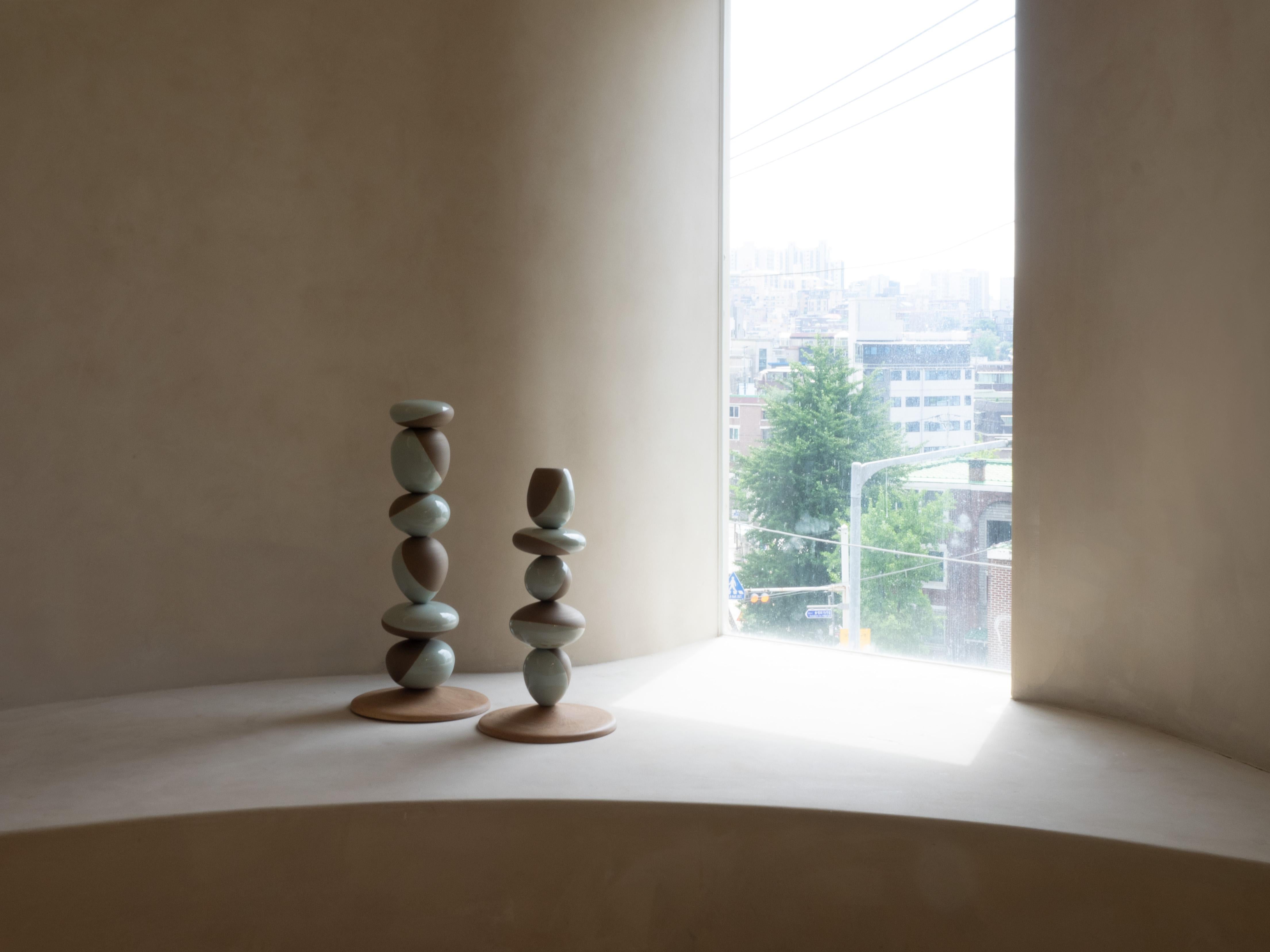 Stack Vessel II by Soo Joo is a stack sculpture made in Korean Ceramic. It is a timeless form, reminiscent of a stack of perfectly balanced river stones. This is the taller of the two sculpture pairs. The Stack Vessel series is created with