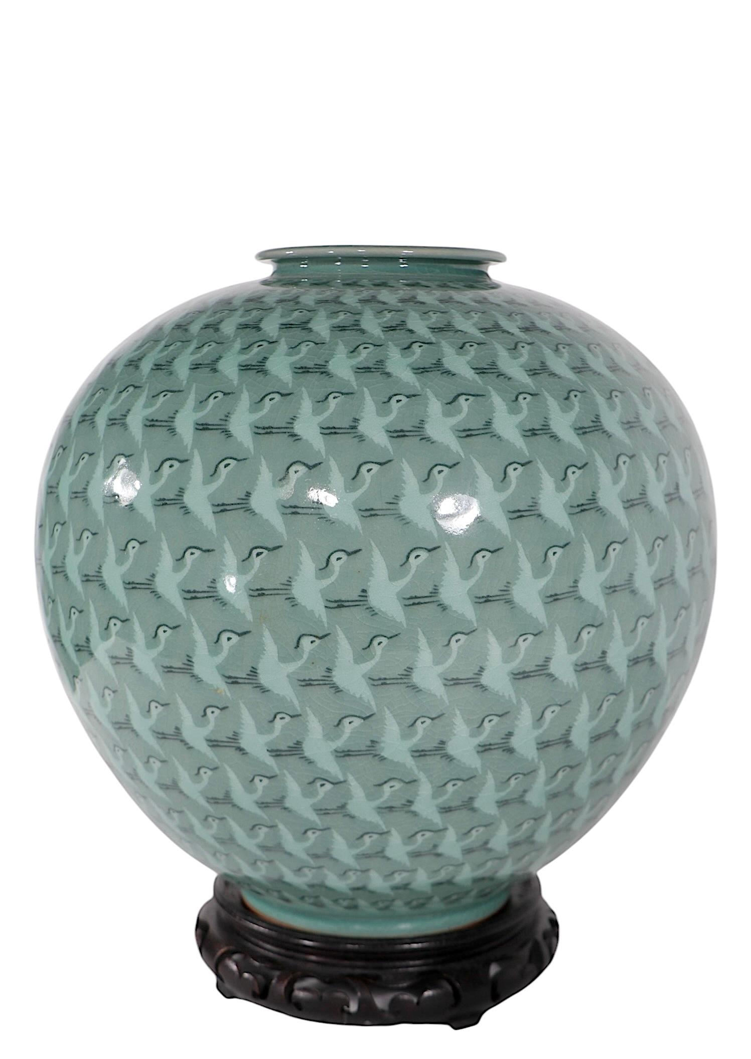 Impressive hand made Thousand Cranes Moon Vase, in perfect, undamaged condition. The vase features an allover pattern repeat of cranes in flight executed in classic Celadon glaze. The vase is signed, possibly by Han Gi Woong, circa 2000/2020.