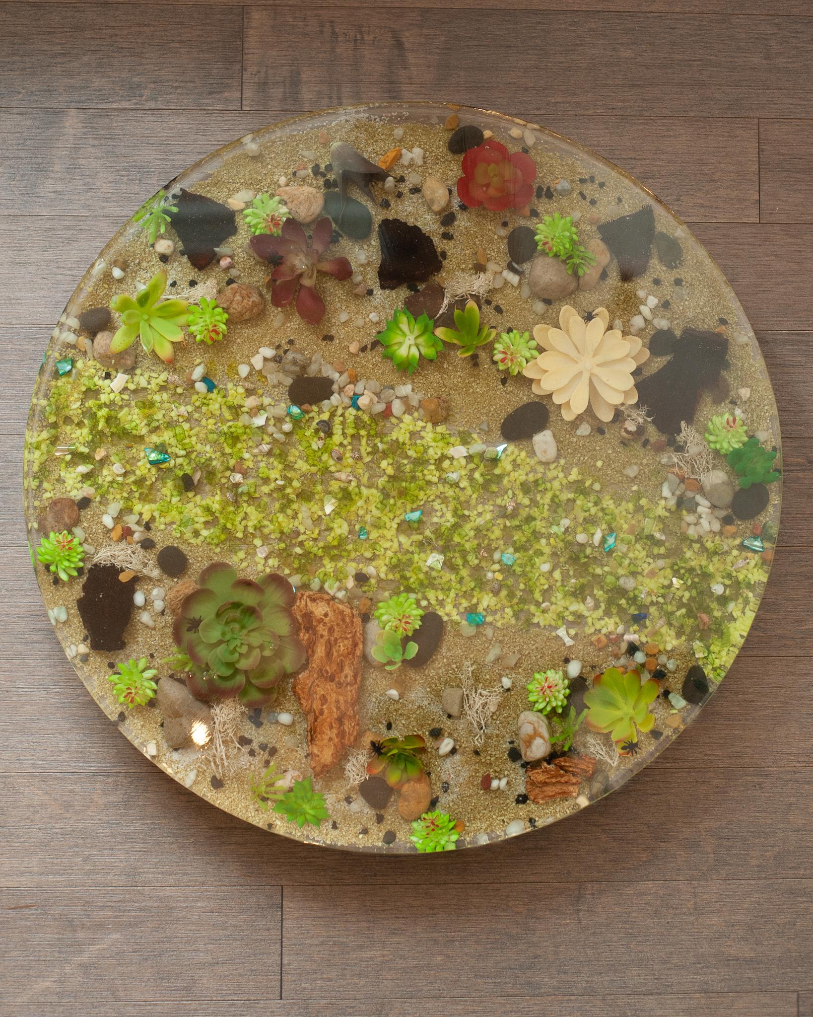 A beautiful large cake serving plate made from poured acrylic with captured faux plants. This thick acrylic plate will enhance any confection placed on top and make for a wonderful serving accessory.