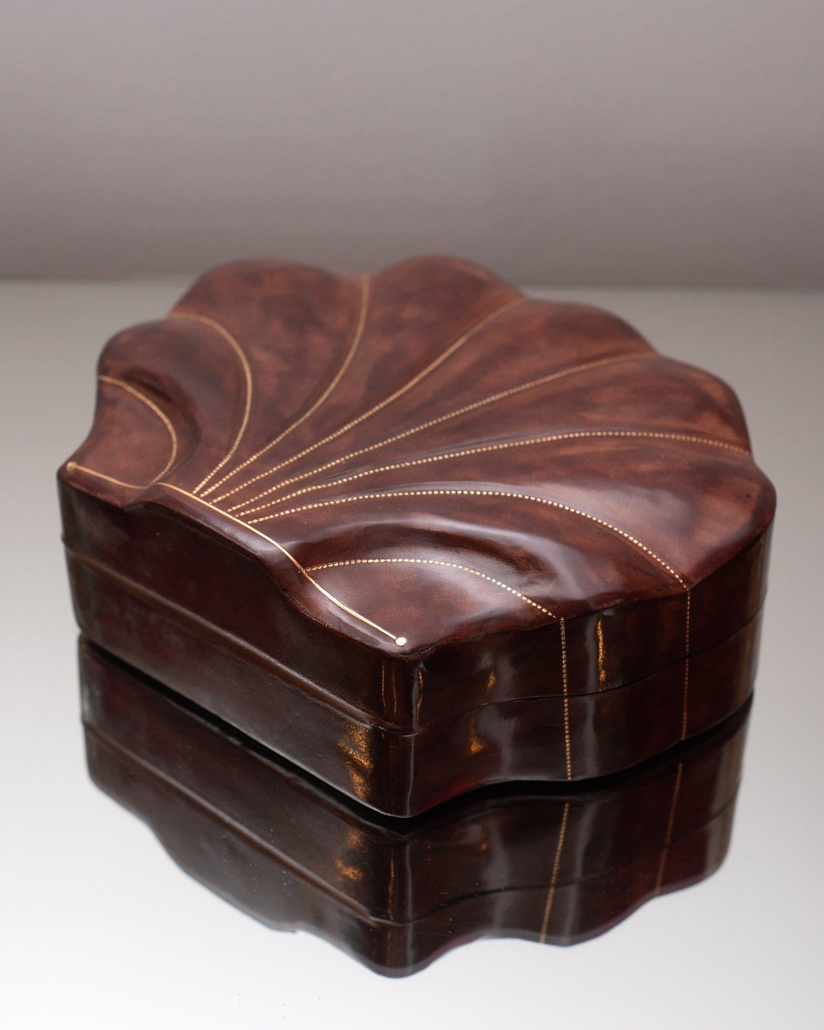 Sourced n a trip to Italy, these sophisticated hand-made leather boxes come from Florence. Florence is known for working with the highest quality of leathers. This large burgundy leather shell box is uniquely hand crafted and finished with gold trim