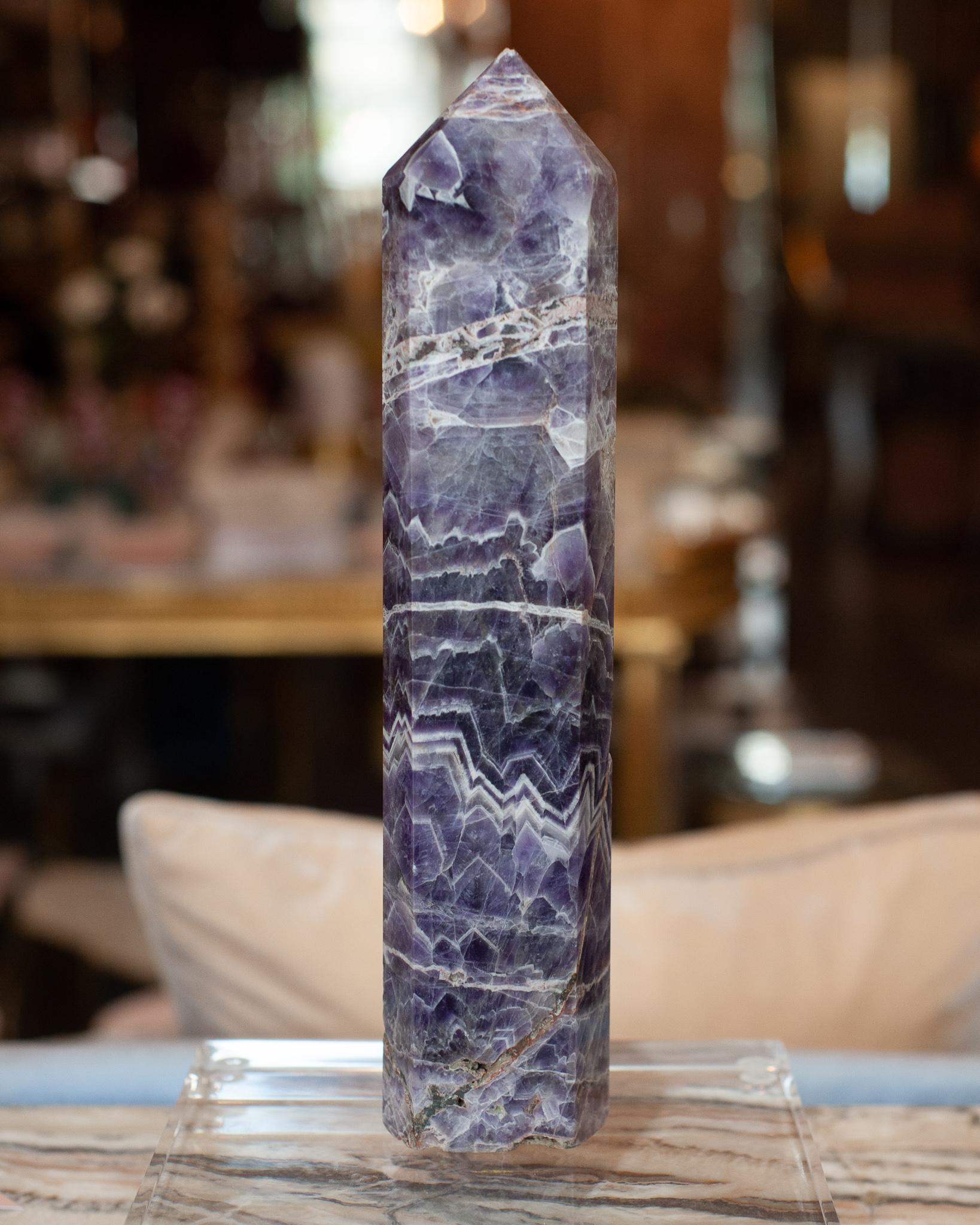 A contemporary large chevron amethyst crystal point / obelisk. Gorgeous in a collection, or as a stand alone statement piece. Obelisks are symbols of protection, defence and stability. Crystal points are often used to direct energies through the