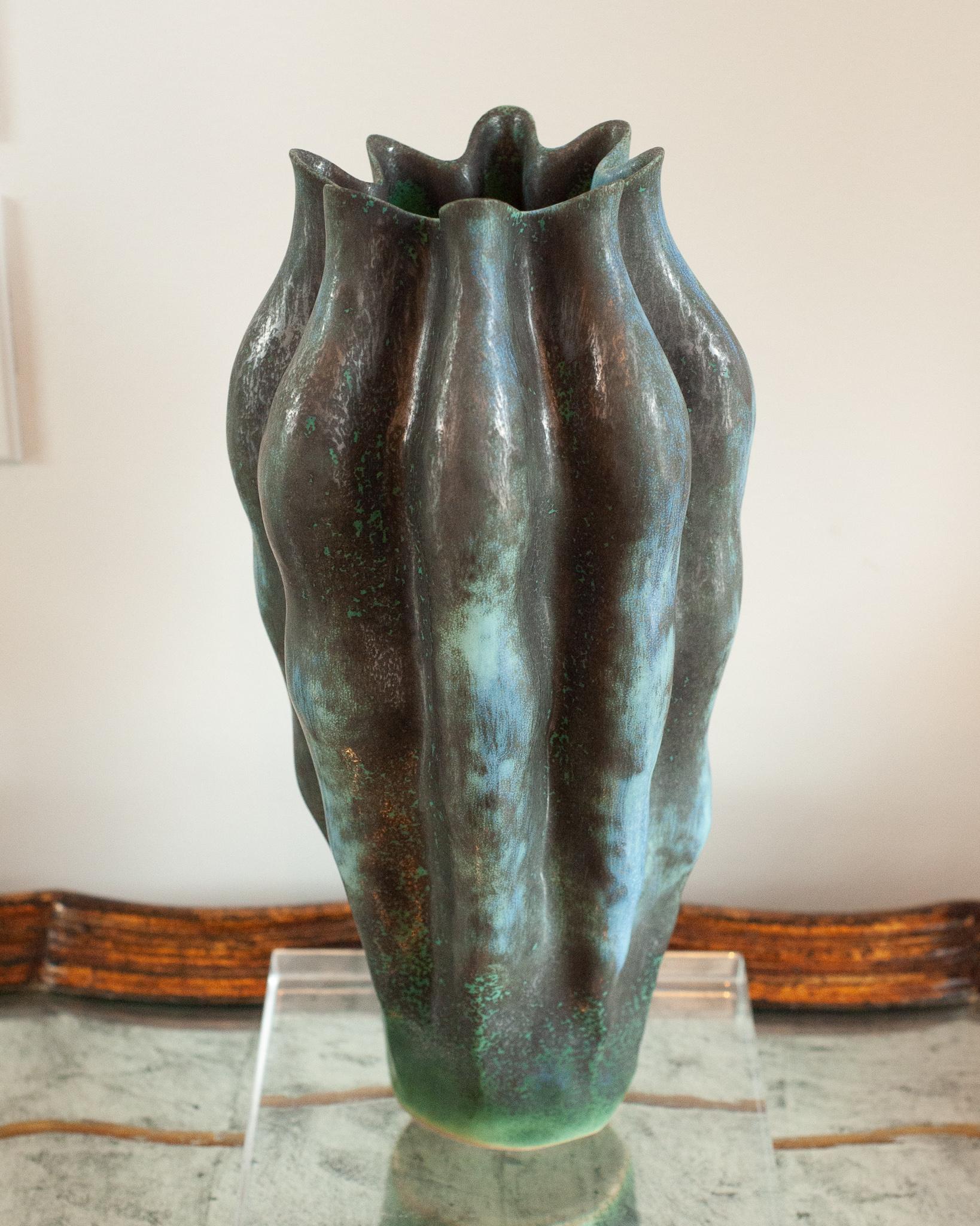 A beautiful large green and metallic glazed vase created by applying layered reactive glazes onto fine porcelain. The perfect large scale sculptural vase that looks gorgeous with or without flowers to fill it.