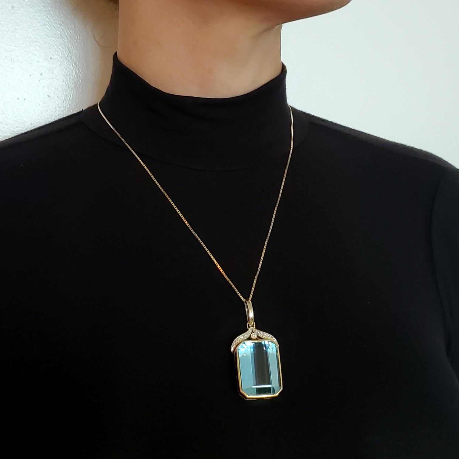 A large pendant with Aquamarine.

Beautiful contemporary oversized pendant crafted in solid yellow and white gold of 18 karats with high polished finish. It is embellished with thirty-six natural earth mined gemstones and fitted on top with a