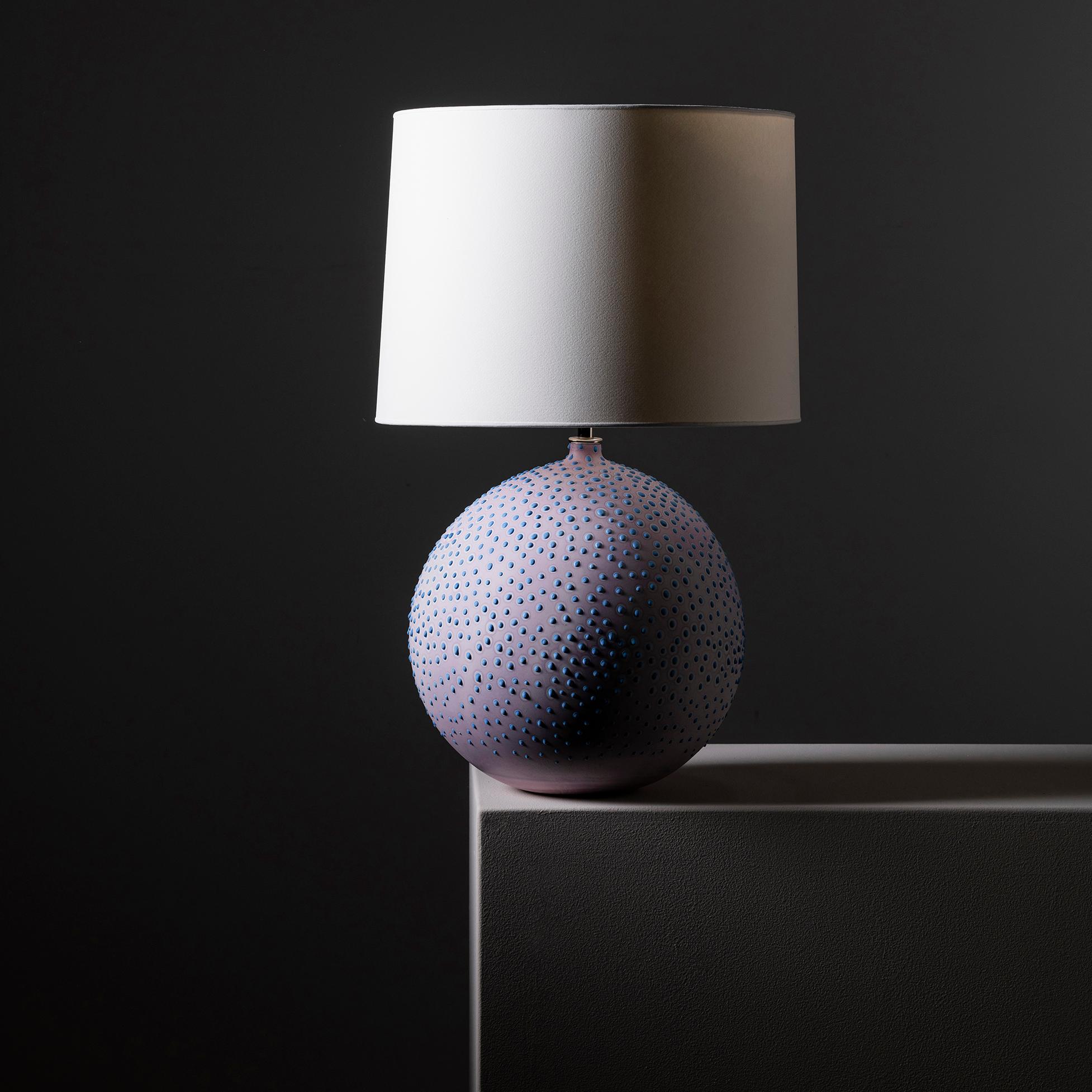 This collection is inspired by the unique galaxy of microorganisms living within each of us. We created a technique for dying and stippling each base that evokes the nature of microbes as they grow and colonize.

The base of each lamp is hand-cast