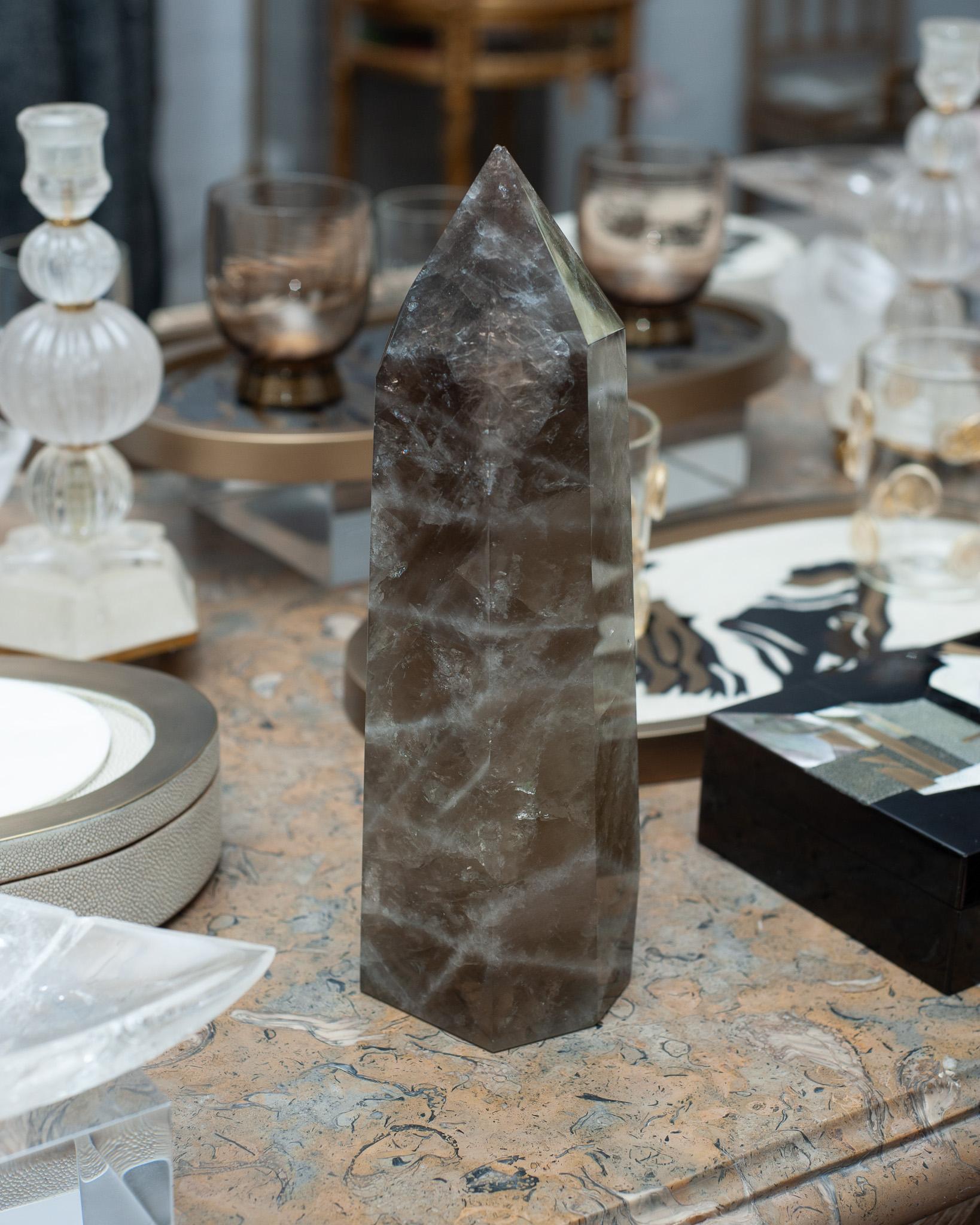 A contemporary large smoky quartz crystal point / obelisk. Gorgeous in a collection, or as a stand alone statement piece. Obelisks are symbols of protection, defence and stability. Crystal points are often used to direct energies through the apex of