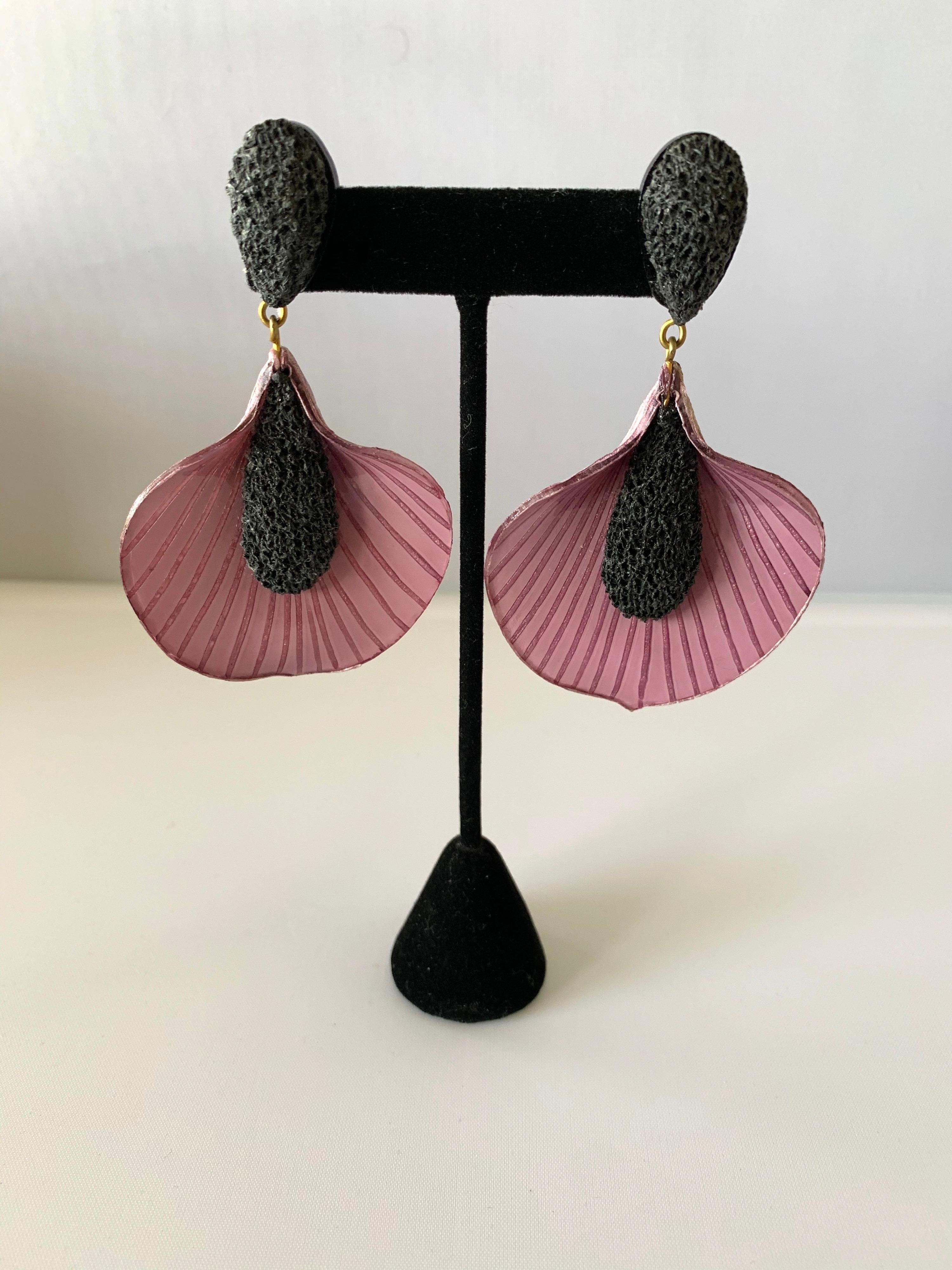 Three-dimensional, artisanal statement earrings by Cilea Paris. The contemporary enamel/resin earrings feature a dramatic yet simple design, showcasing oversized lily flowers - the combination of the two colors and texture gives the earrings dept