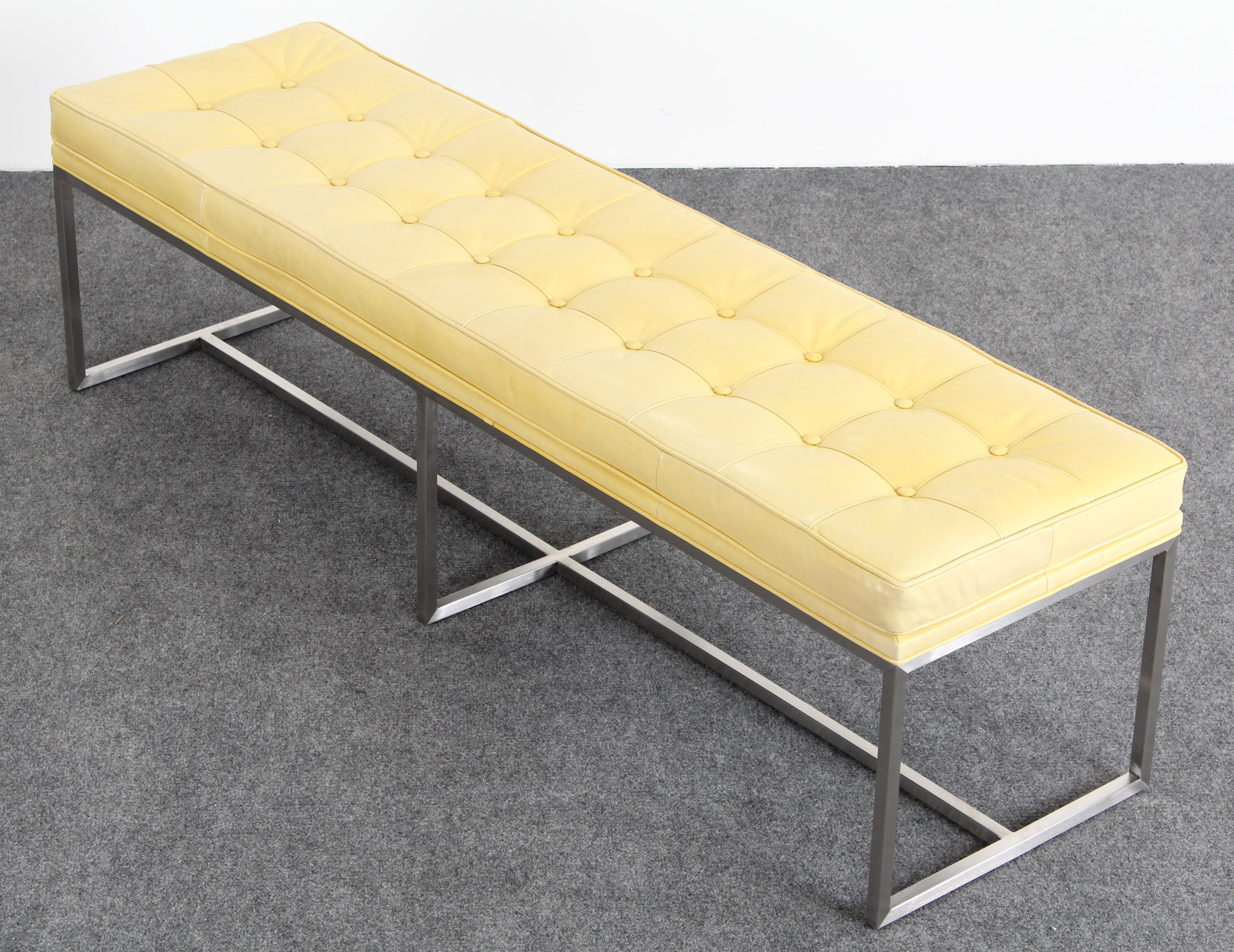 A modern and sleek contemporary leather and stainless steel bench, 2013. Labelled 