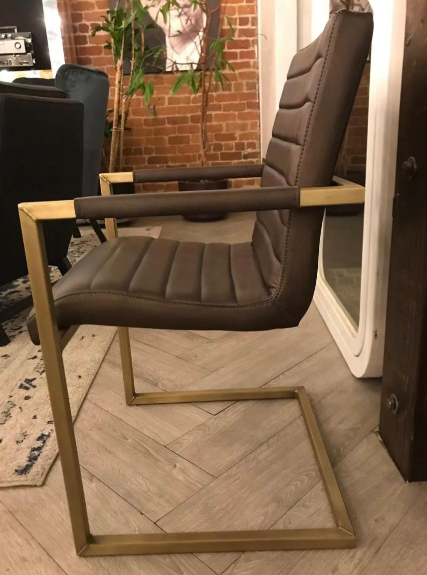 Deep olive green accent chair with attractive antique brass frame and leather seats. Bring your surroundings into a cool contemporary feel, while adding character and class with this piece. 