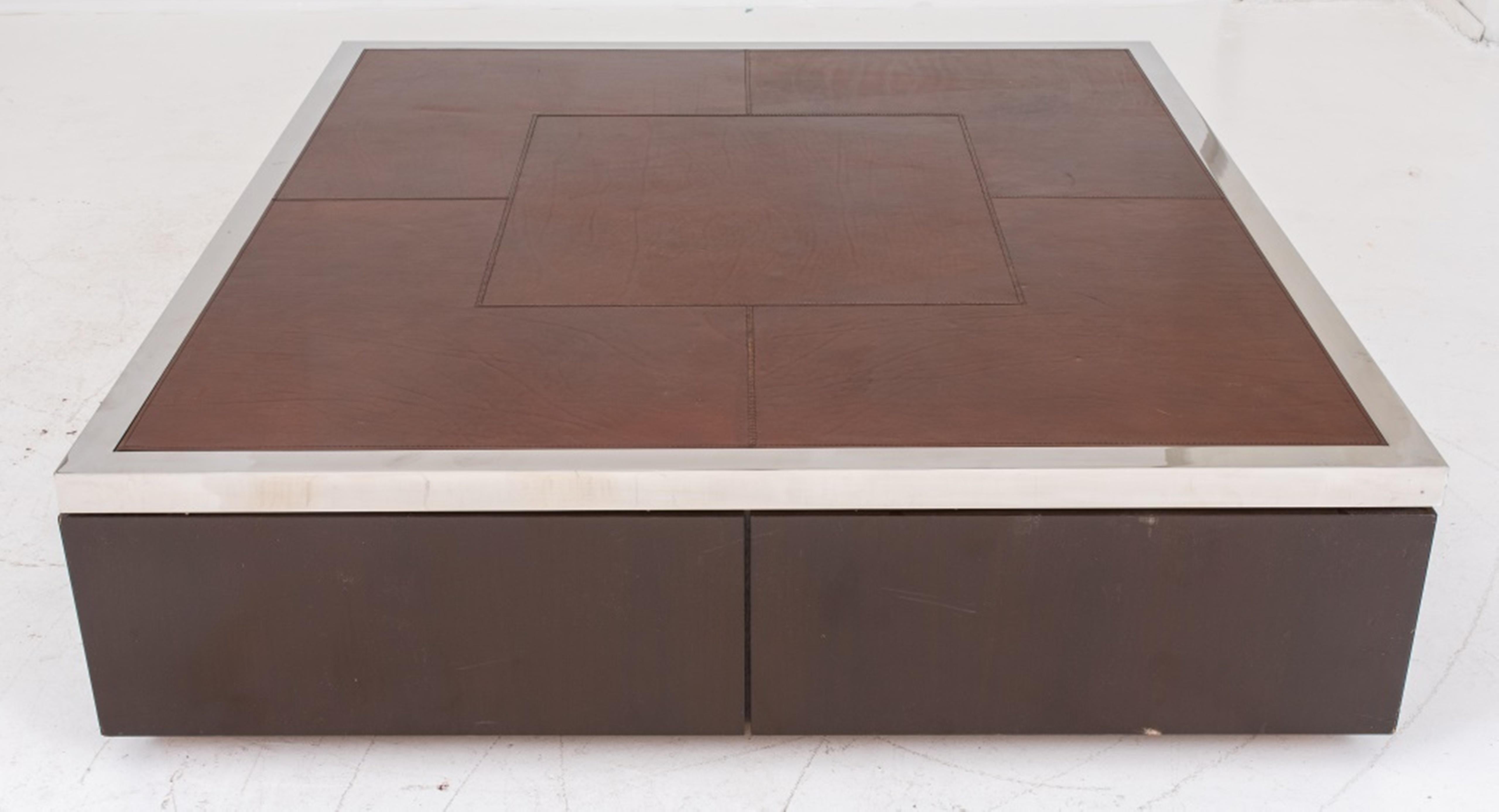 Monumental minimalist custom built leather, chrome, and wood coffee table, with leather face, metal rim, and drawers beneath for storage.

Dealer: S138XX.
