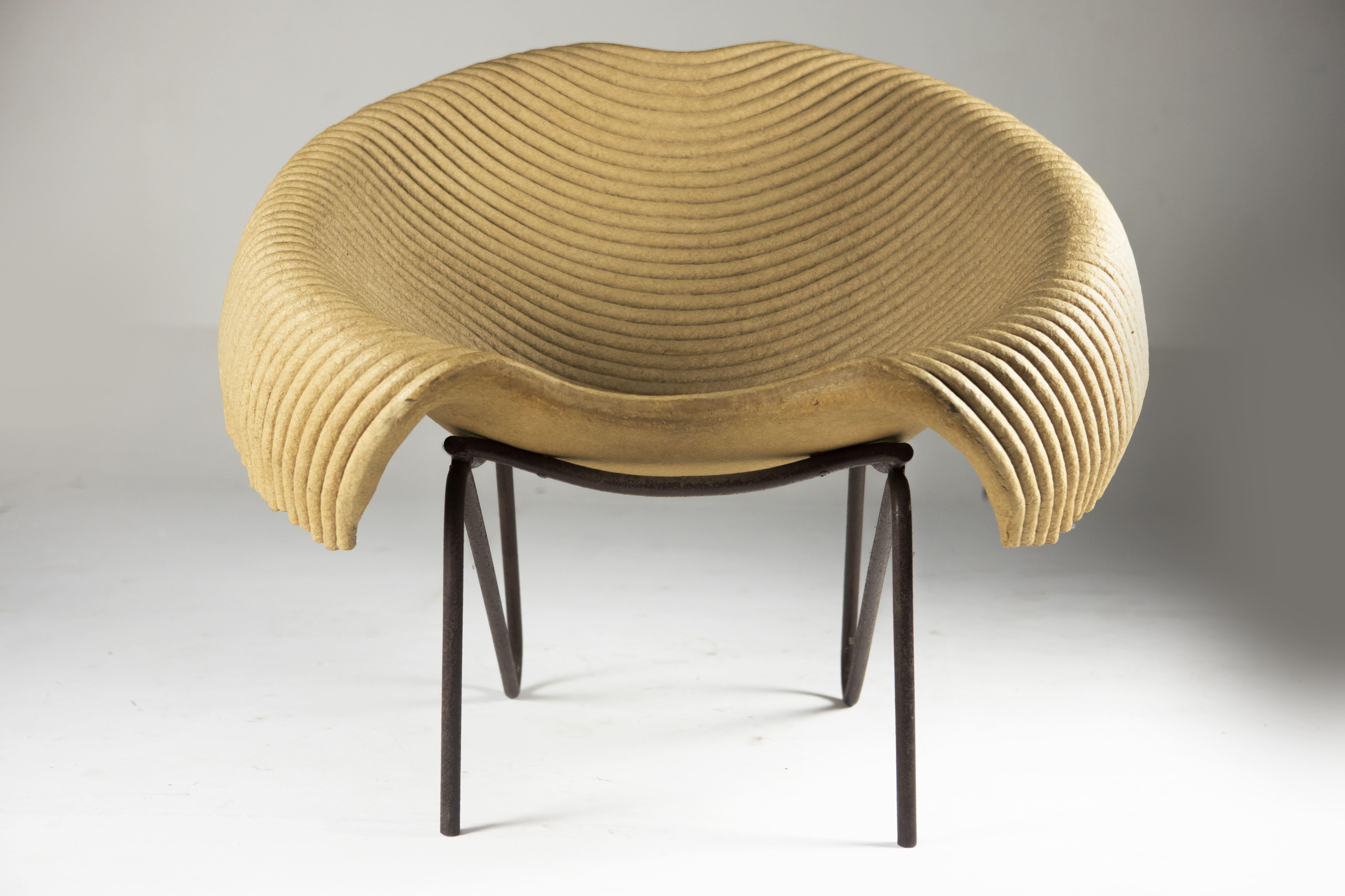 The Contemporary Leiras Lounge Chair by Domingos Tótora is a stunning example of the designer's commitment to sustainability and innovation. The chair is crafted entirely from recycled cardboard, which has been carefully layered and molded to create