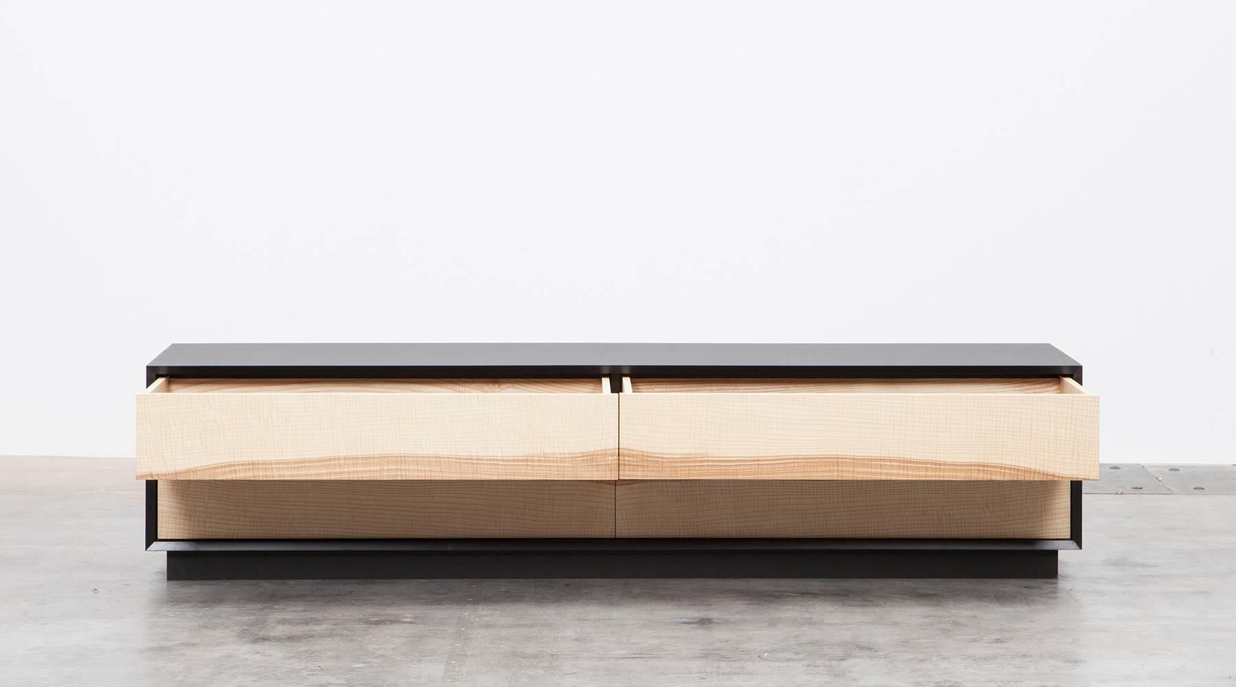 Sideboard by contemporary German artist Johannes Hock. The front of the doors of this unique piece comes light charming ash without handles to the outside. The inside life of the four drawers are designed with red or black HPL, as well as the