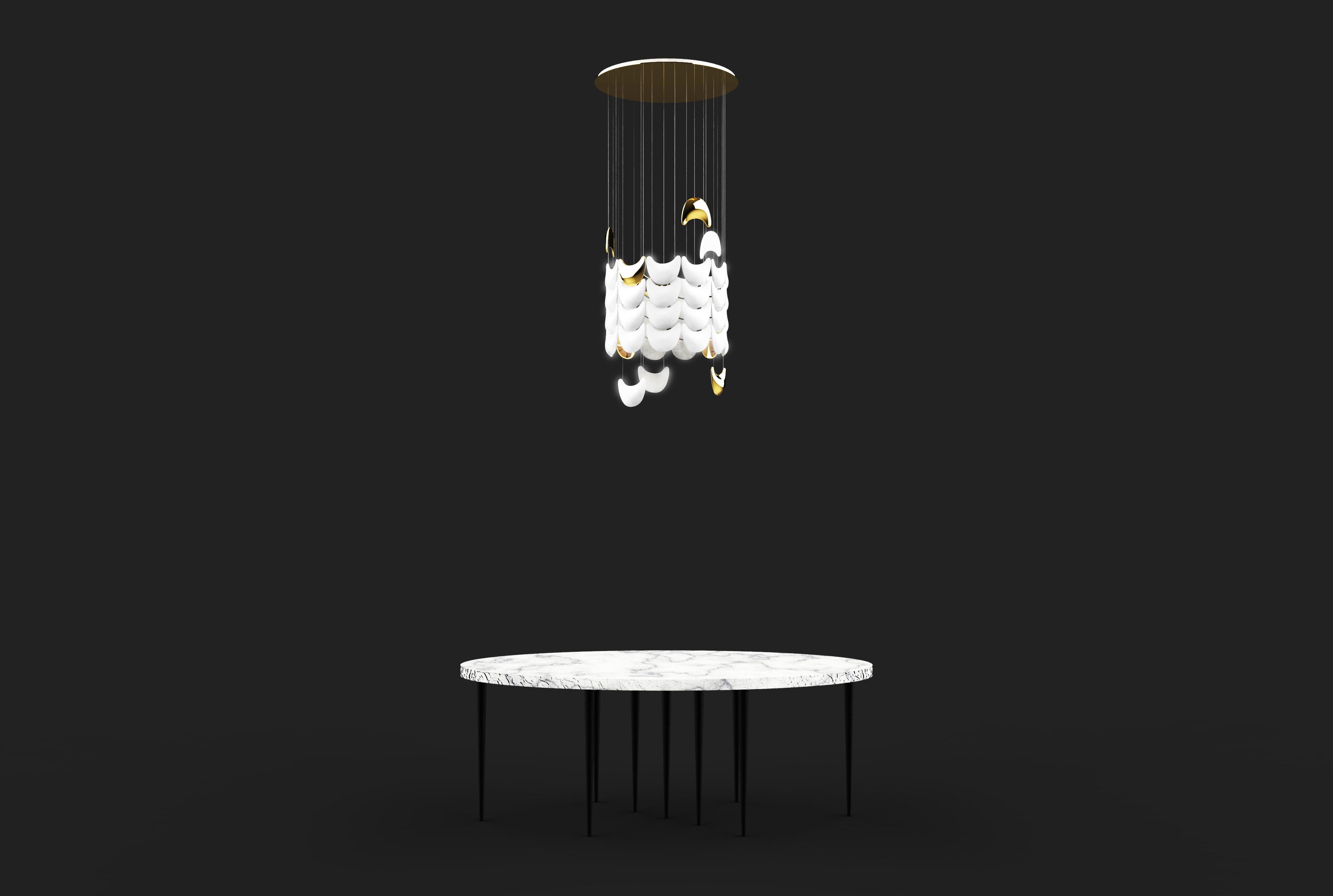 The light skin lamp shade bespoke chandelier is designed by Sylvie Maréchal and it is entirely manufactured in France. This chandelier is made of 50 Limoges porcelain scales shaped pieces of which 7 are fine golden tubes and 43 are white scales