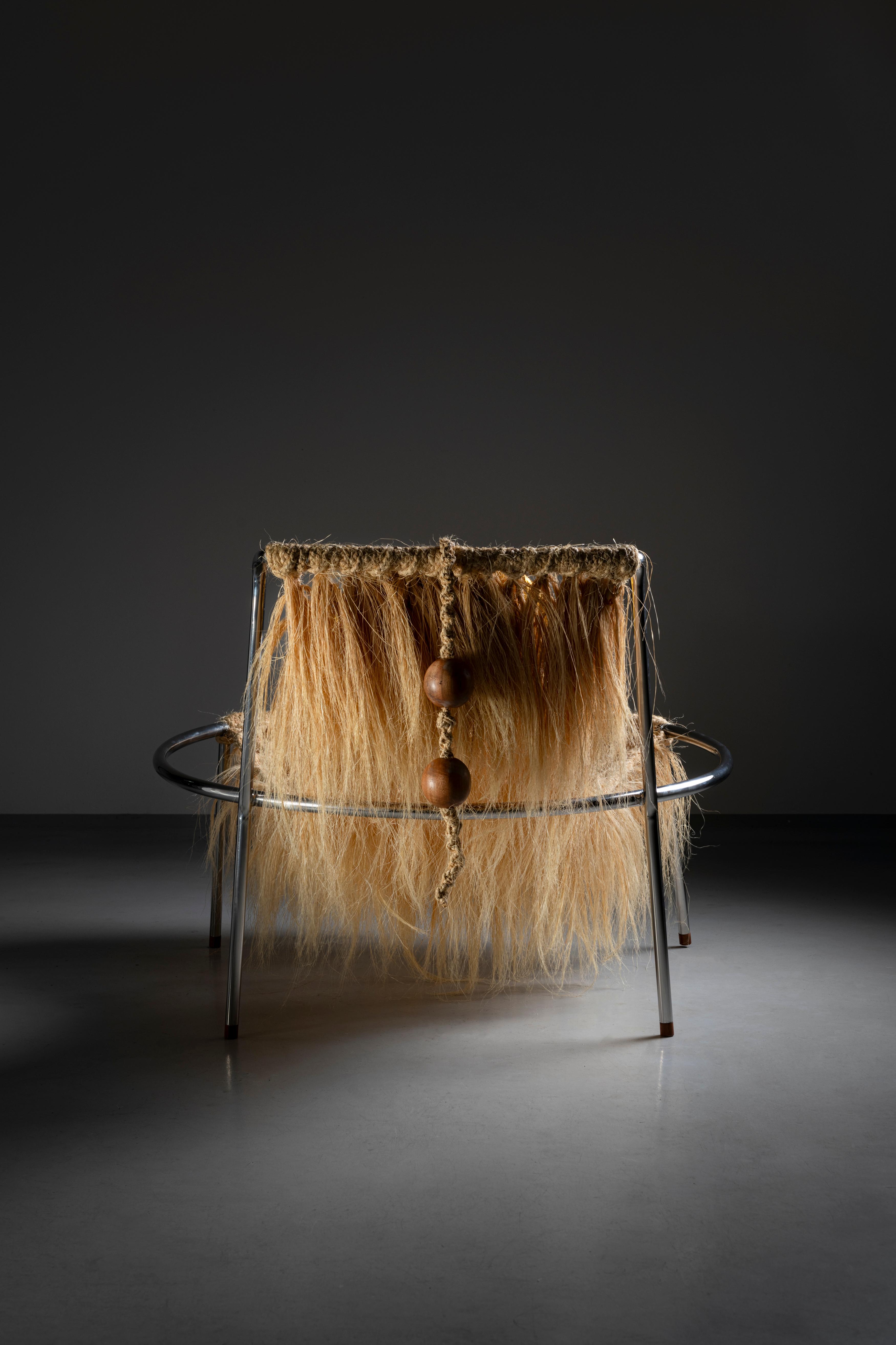 Inspired by Lina Bo Bardi's modernism, this piece features a low, relaxed seat and a metal circle that provides aesthetic strength and extreme visual lightness. This is a special, limited edition of 10 units of the armchair launched in 2018 by the