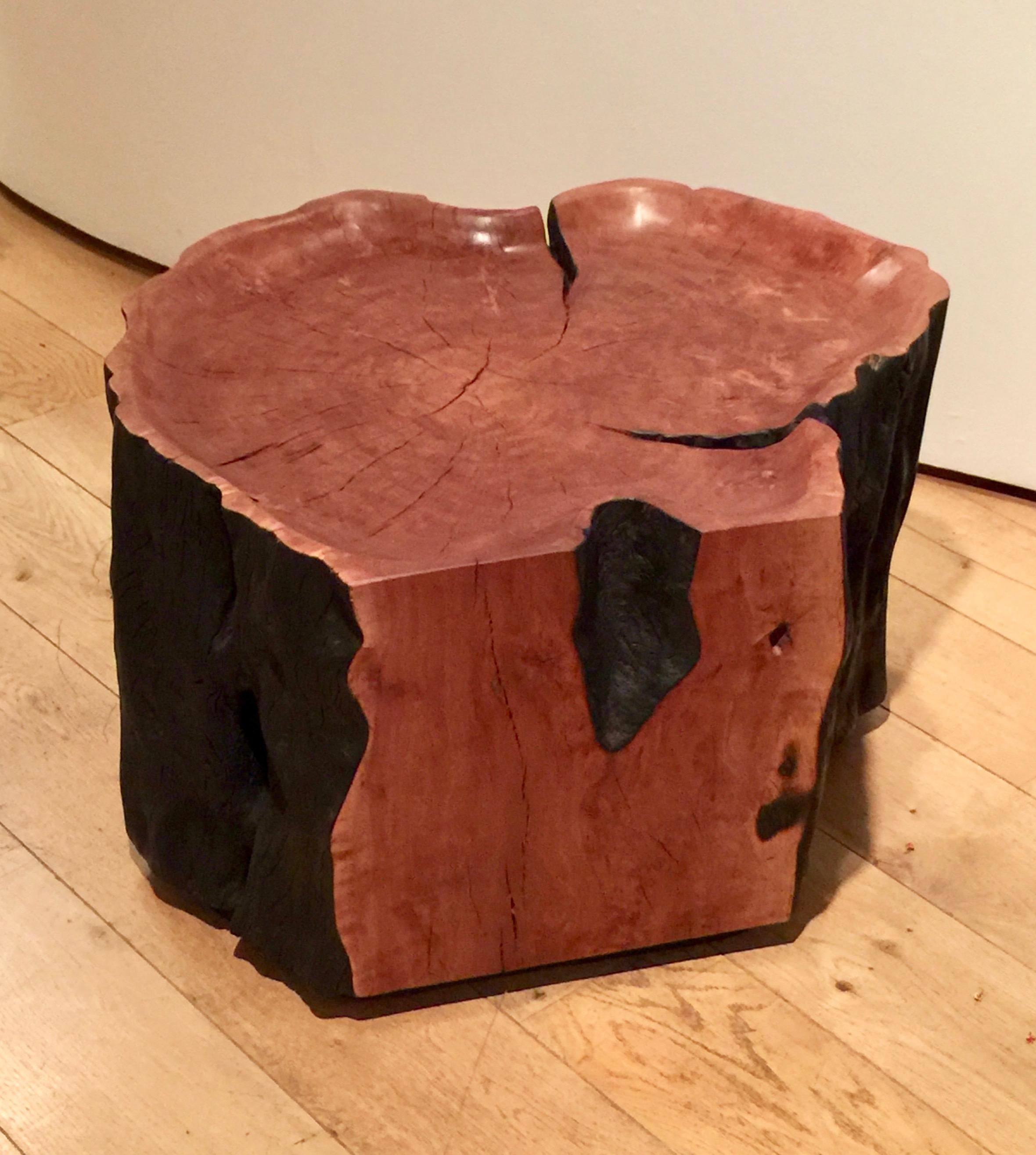 Shaped from a section of a reclaimed litchi tree trunk, the polished top has a soft finish dramatically contrasting with the natural dark bark.
 