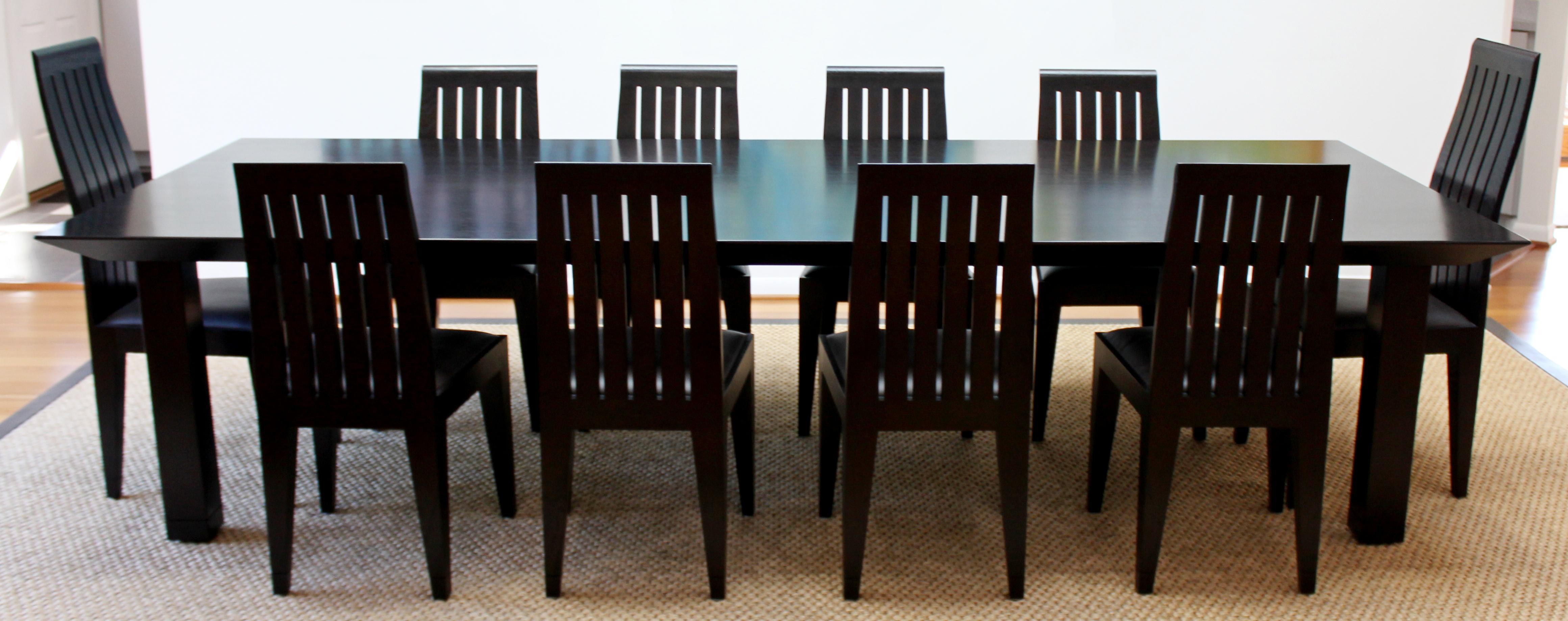 For your consideration is an extraordinary dining set, including a long black wood table and set of ten side dining chairs by Ohashi, 2 captain chairs and 8 side chairs, circa the 1980s. In excellent condition. The dimensions of the table are 140