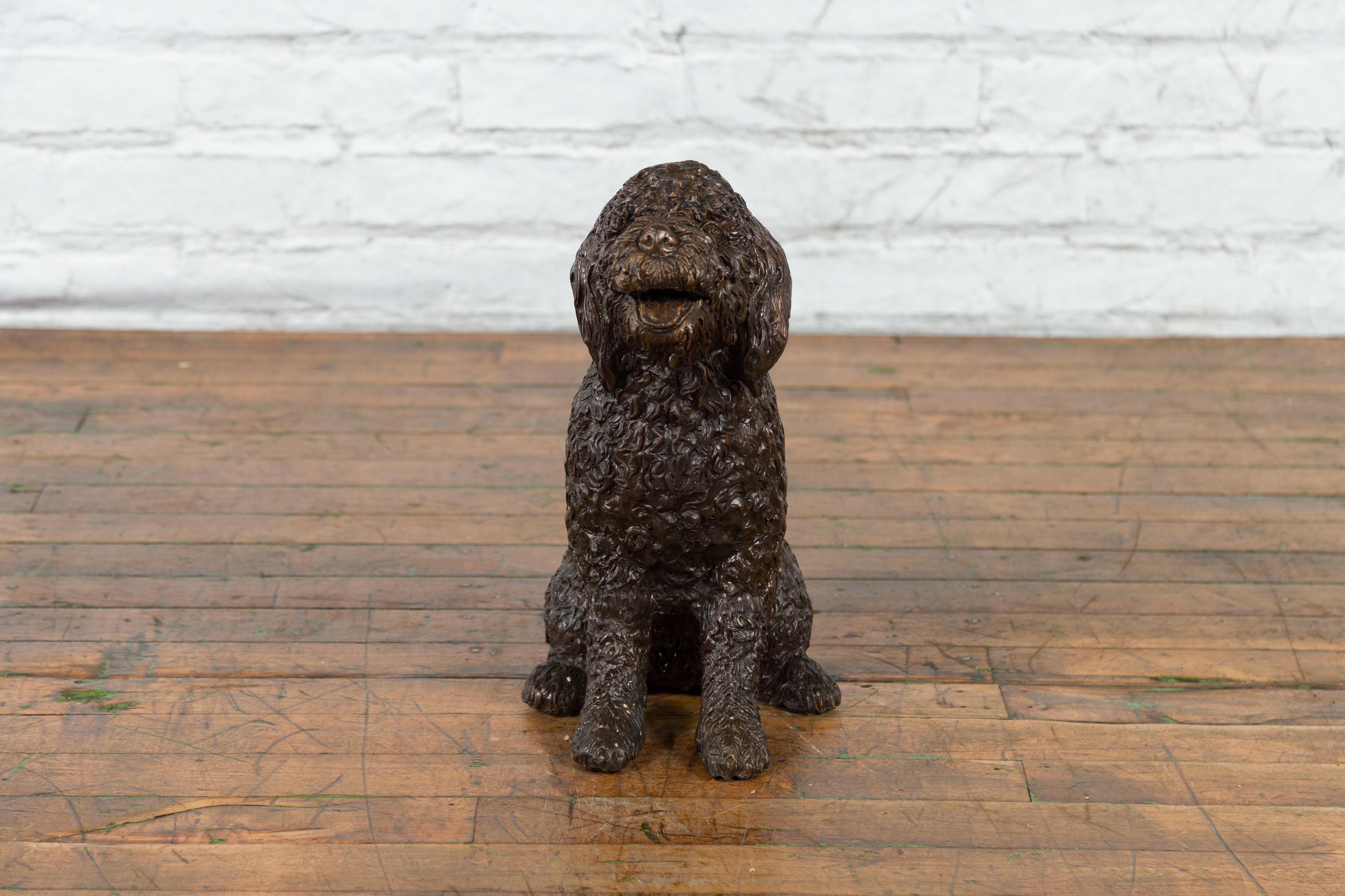 A contemporary bronze statue of Max the Labradoodle, with hand-applied textured bronze patina. Created with the traditional technique of the lost-wax (à la cire perdue) which allows for great precision and finesse in the details, this charming