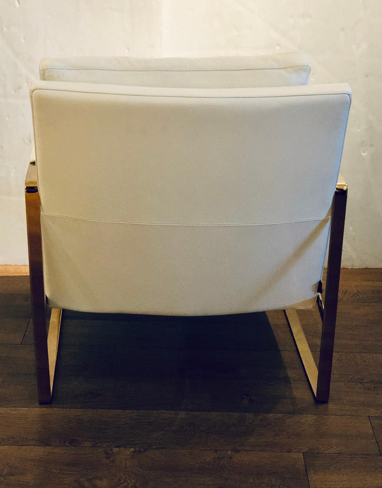 Beautiful armchair in the style of Milo Baughman in a cream color leather and a brass plated steel frame, this chair its like-new condition elegant solid and sturdy, retails for over $2000.