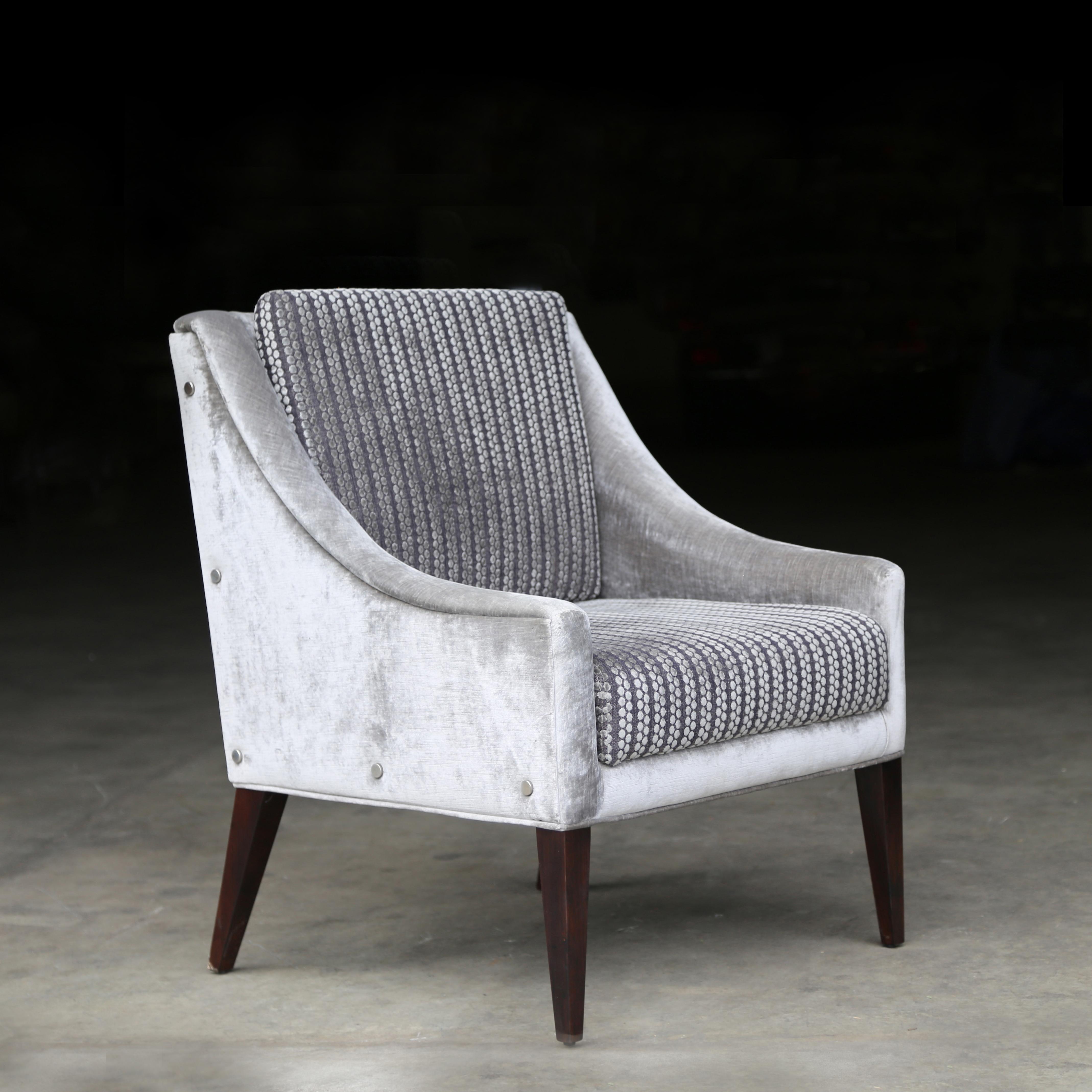 Lucina Modern Upholstered Lounge Armchair from Costantini, in COM/COL

This elegant lounge chair with contrasting Kravet fabric and polished steel button details features gently sloping arms and dark Argentine Rosewood legs. Available as shown for