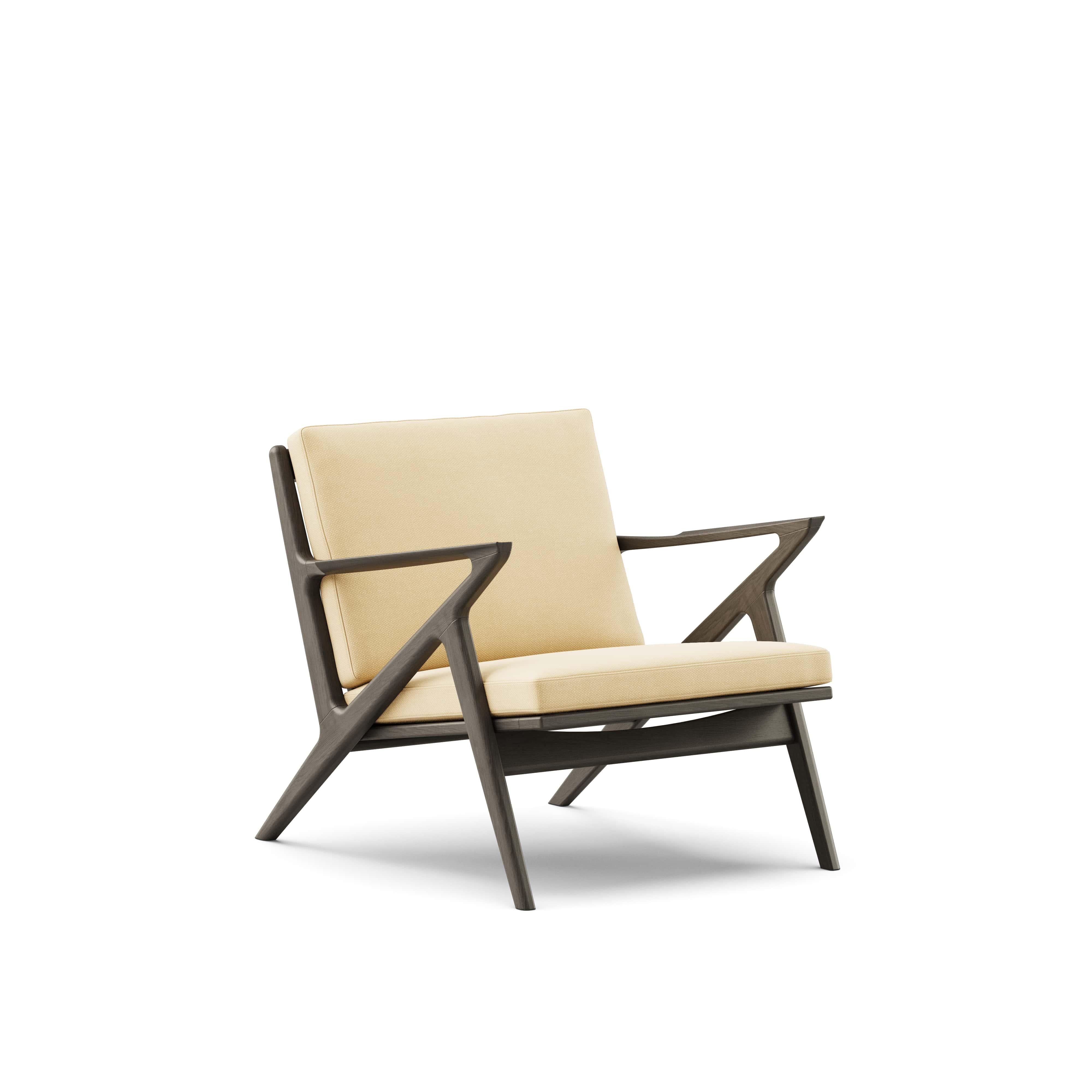 Zeitgenössischer Loungesessel 'Z-Chair' von DK3
Entworfen von Poul Thorsbjerg Jensen

Abmessungen: 
- B.75 x T.82 x H.62 cm
- Sitzgelegenheit: B.58 x T.52 x H.36 cm

MATERIALIEN: 
- Rahmen: Massivholz.
- Sitz und Rückenlehne: Polsterung.

Modell auf