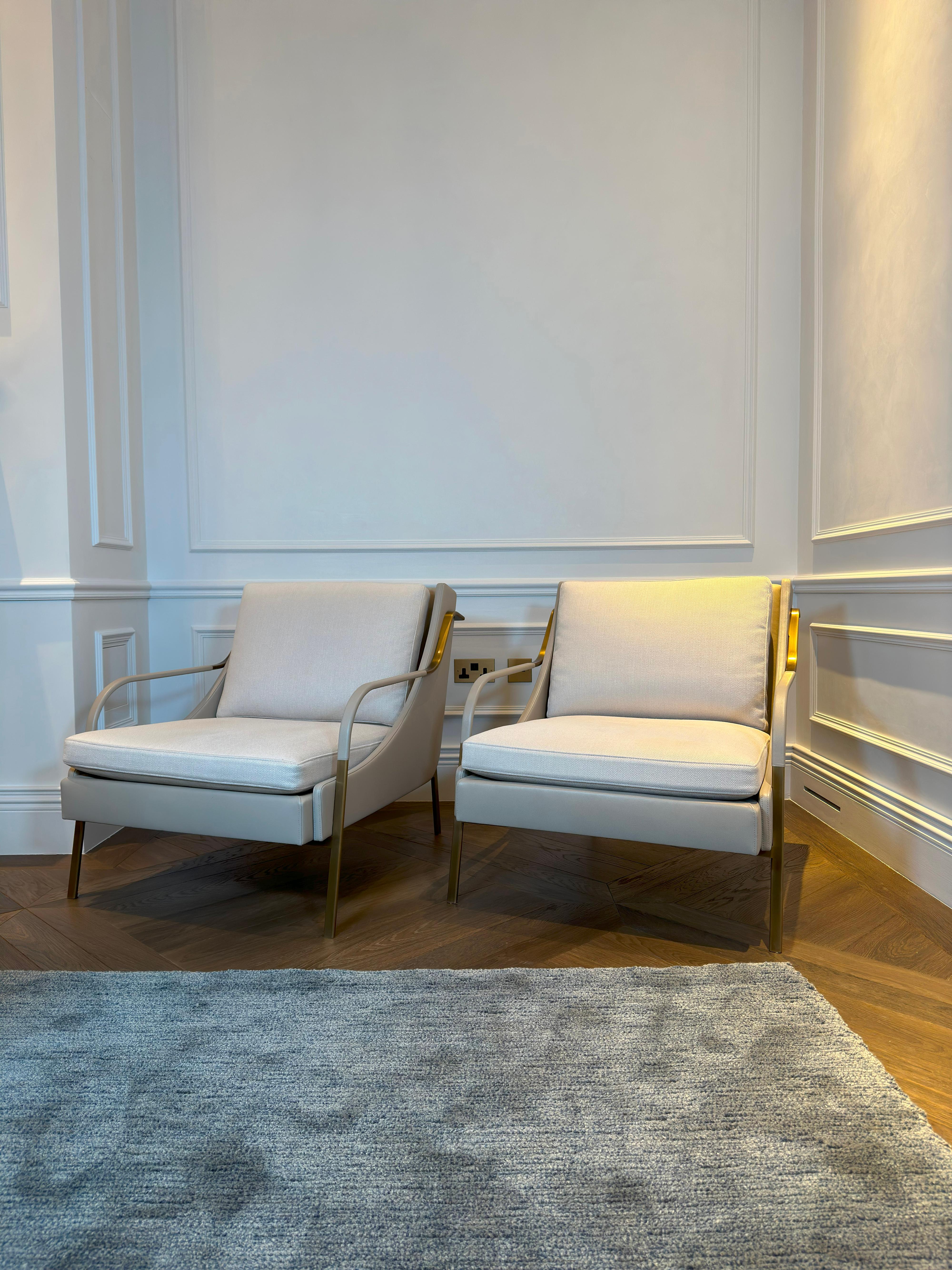 A refined pair of contemporary lounge chairs by Holly Hunt Studio, the Harlow model draws direct inspiration from a 1940s French armchair, reimagined through a minimalist yet glamorous lens. Aptly named after Hollywood icon Jean Harlow, the design