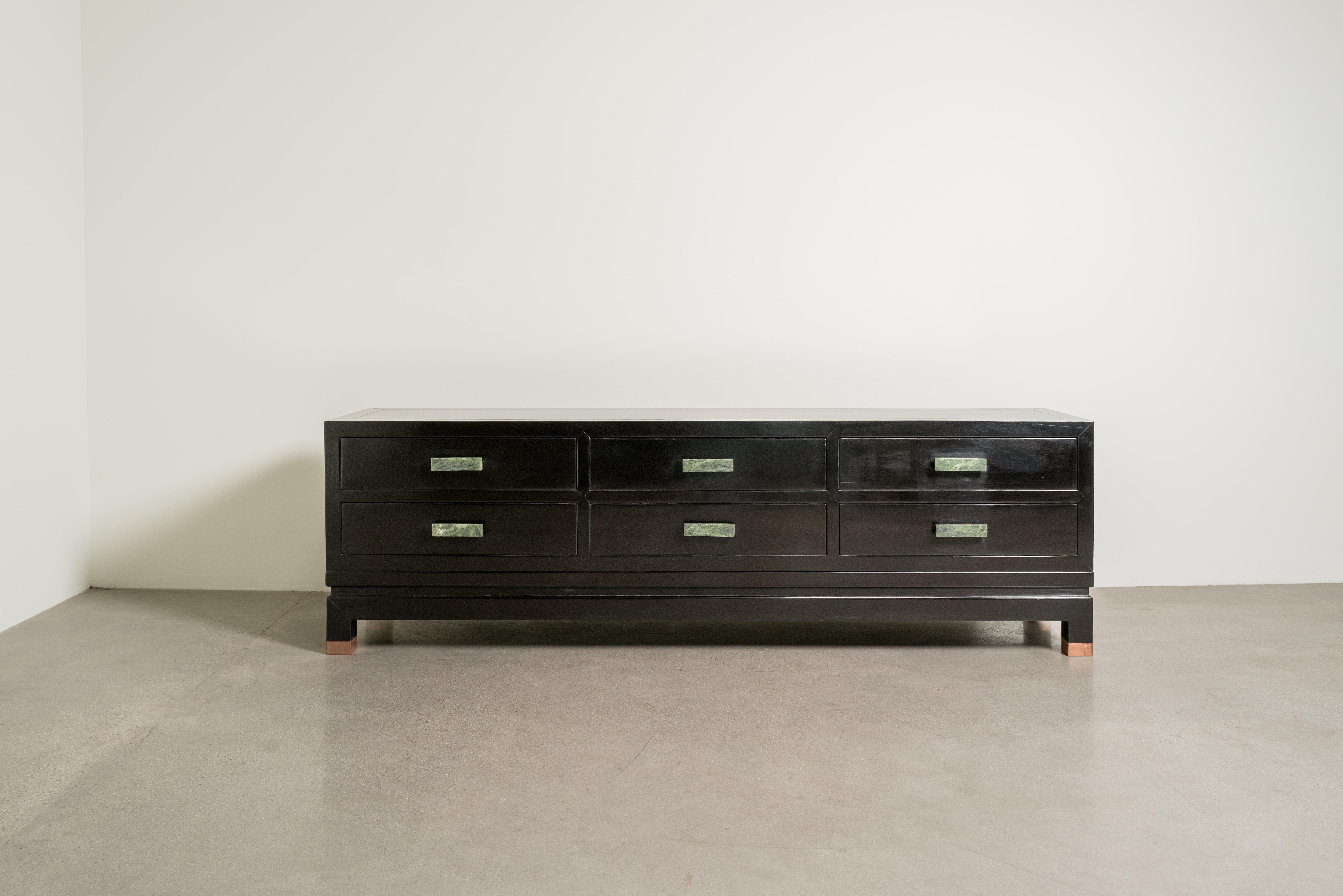 Low Hua Li Cabinet w/ Jade Handles
Hua Li Wood (Chinese Rosewood)
Jade Handles
Hand Carved 
Copper Feet
Hand Repoussé
Lacquered Wood
Limited Edition. Each piece is individually crafted and is unique. 

Known as the “Stone of Heaven,” Nephrite Jade