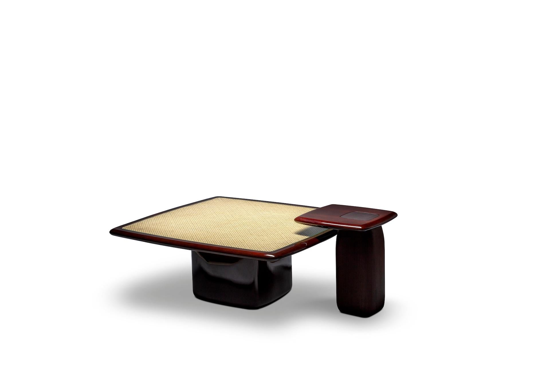A composition that includes a set of one coffee tables and one side table. The square coffee table features a high gloss mahogany solid wood combined with natural cane and glass at the top.

The side table features a high gloss mahogany solid wood