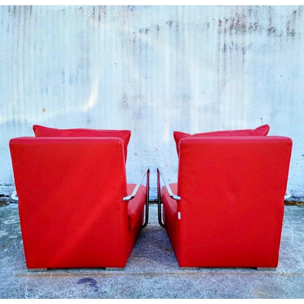 A stunning pair of vintage Luciano Frigerio lounge chairs. A bright clear red leather with sleek chrome arms. Gorgeous and comfortable. High sexy backs. Acquired from a Miami estate.