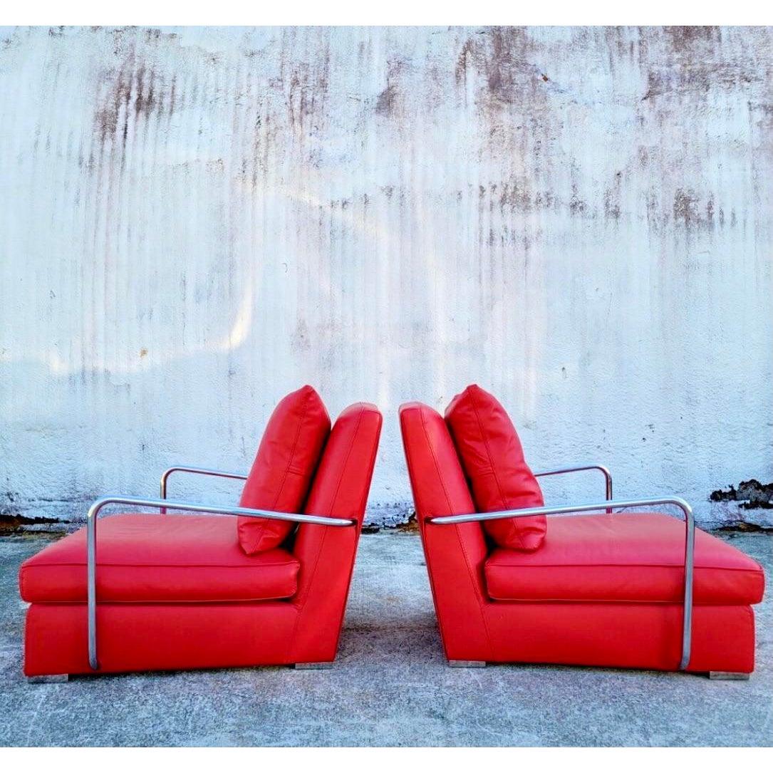 A stunning pair of vintage Luciano Frigerio lounge chairs. A bright clear red leather with sleek chrome arms. Gorgeous and comfortable. High sexy backs. Acquired from a Miami estate.
