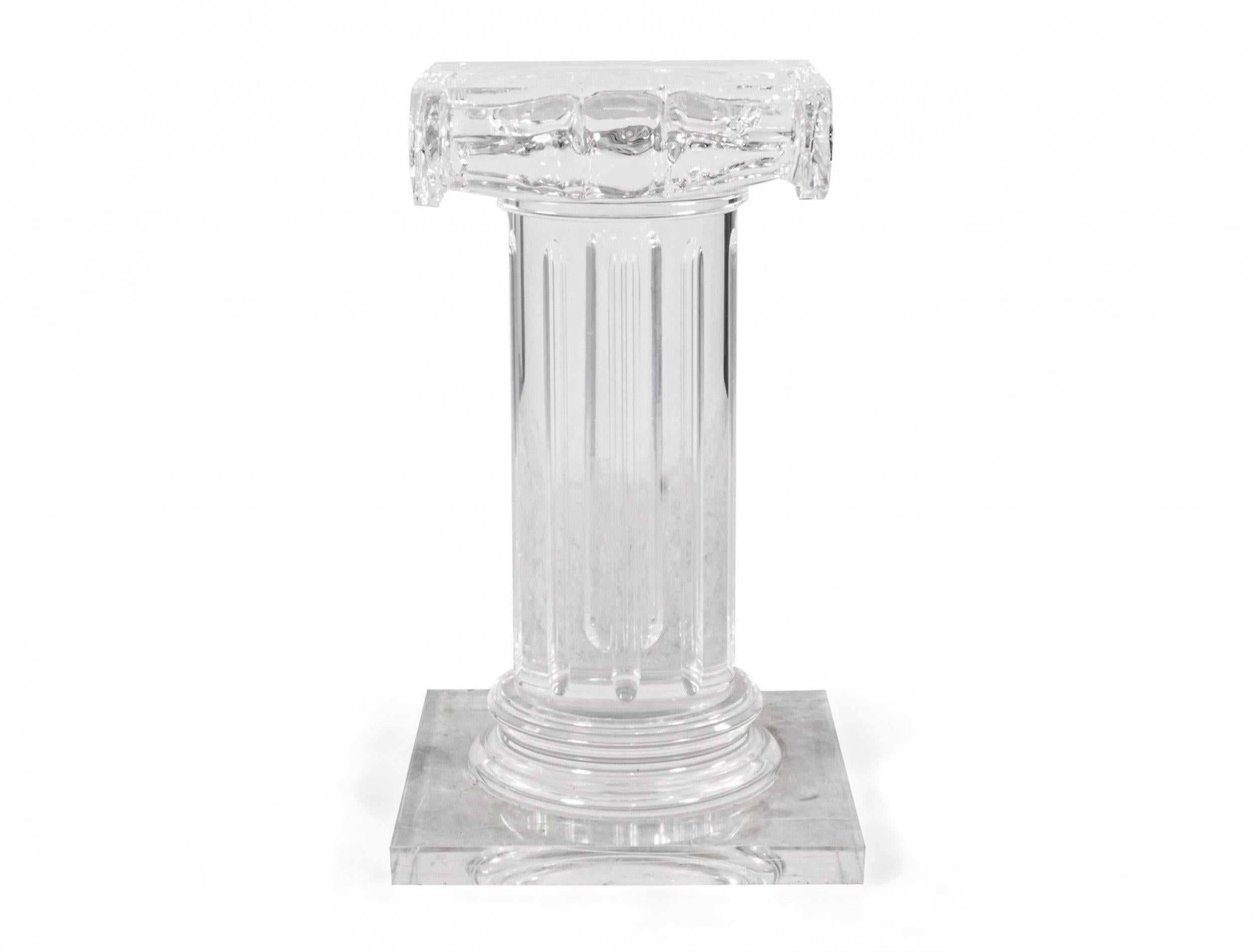 Contemporary Hollywood Regency-style Lucite column-shaped pedestal with ionic capital.
 