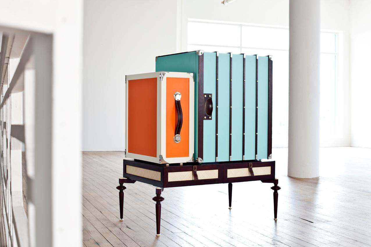 Small minibar cabinet in wood, lacquer and metal legs with mini fridge, liquor cabinets, and a base large drawer.

The fine line of St. Barths collection are inspired by the furniture and luggage explorers carried on their journeys through the