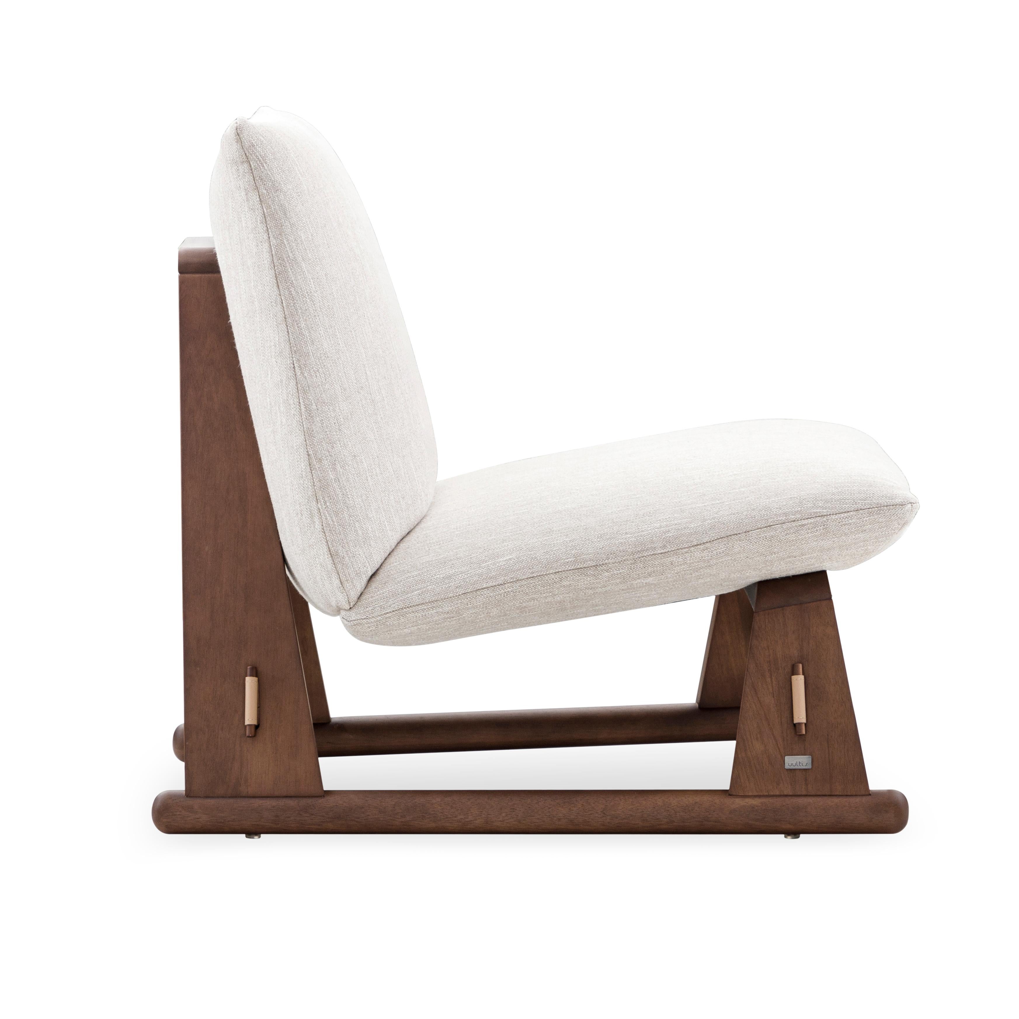 The Contemporary Maia chair is a new way to relax in its walnut wood finish and the upholstered off-white fabric that covers it. The Uultis team has created this chair with a seat and backrest that are made of MDF, it has elastic straps and a