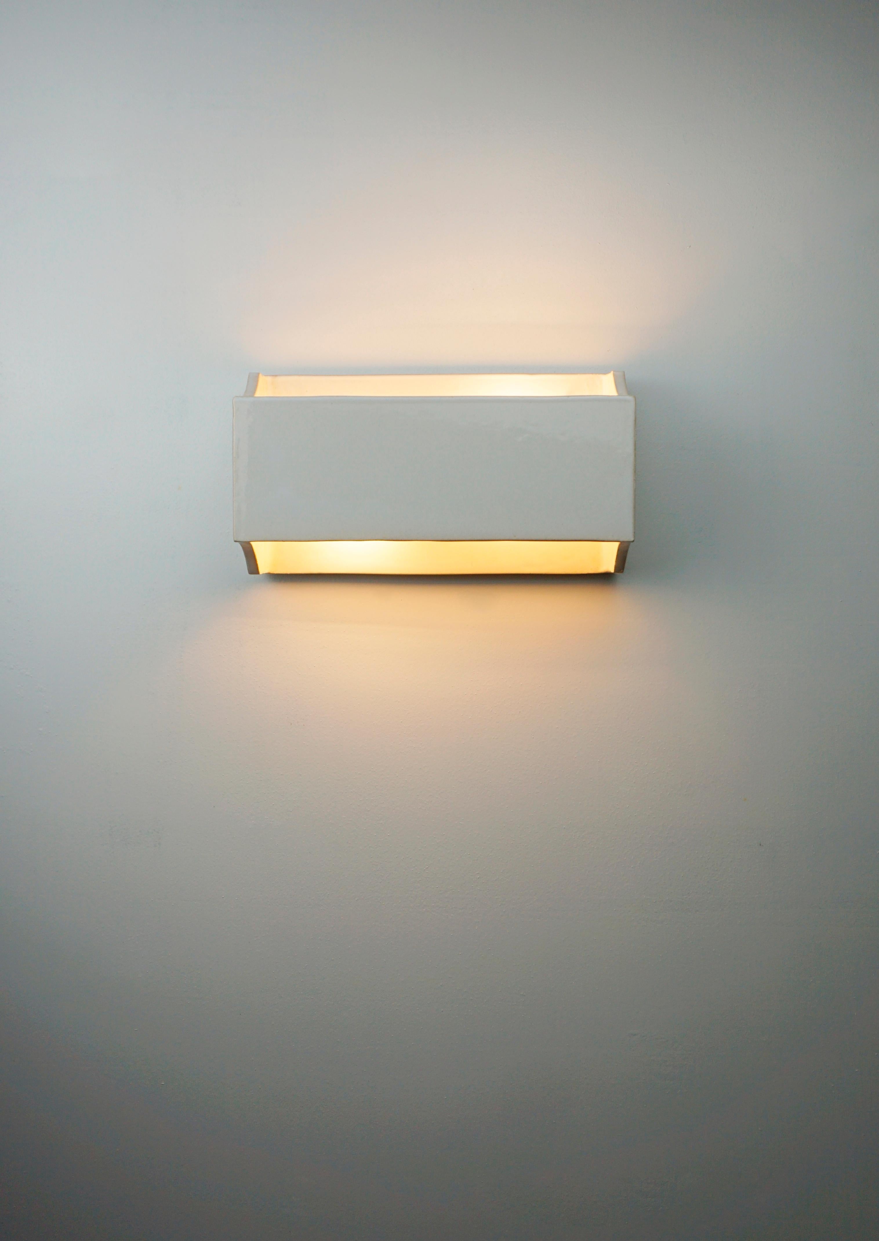 Wall light hand crafted with lighting above and below. The electrical connection of the lamp is suitable for both the American and European markets. The interior of the piece is vitrified in white to achieve a better use and projection of light (The