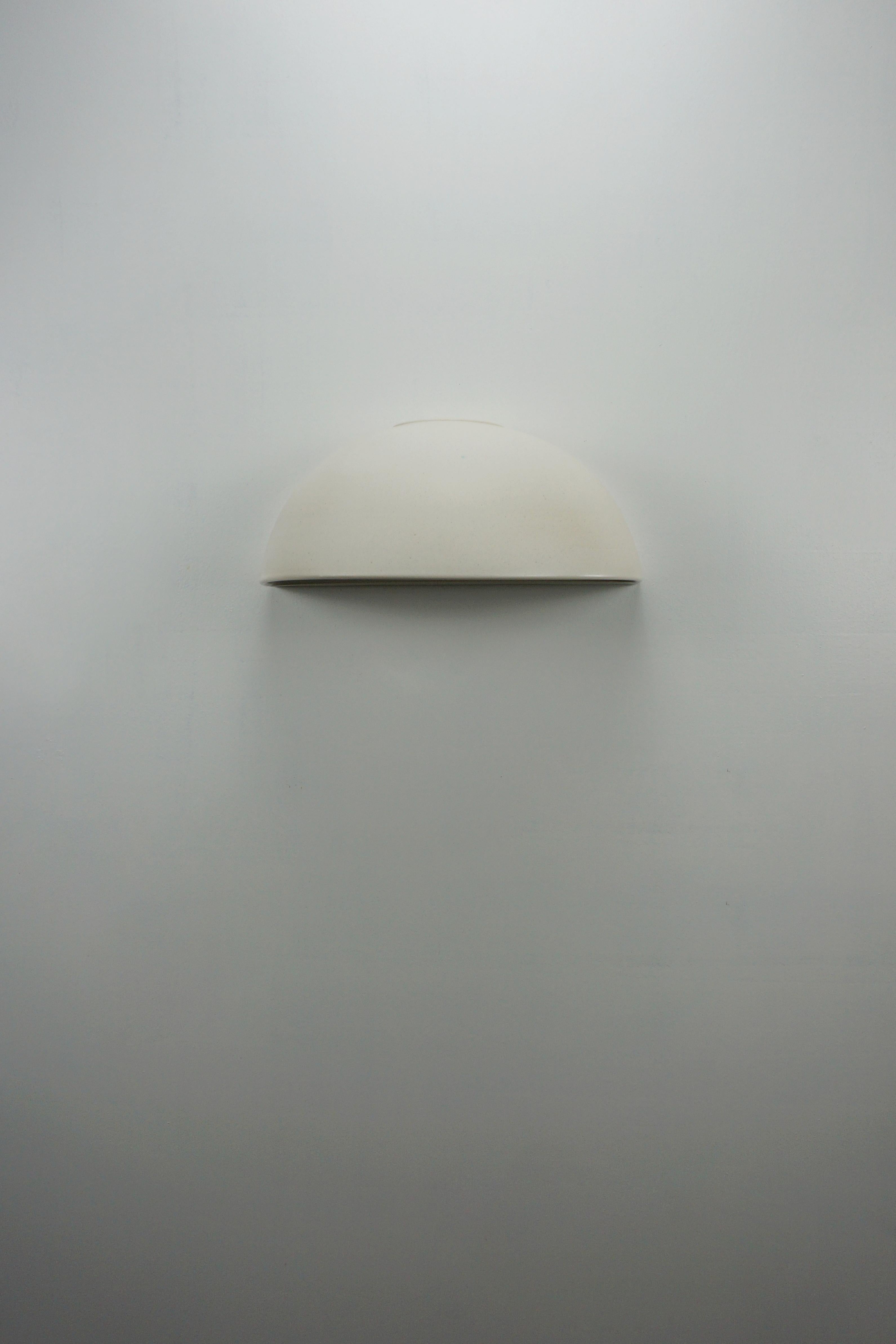 Ceramic Hand - Crafted wall sconce, designed and signed by Rulo and Manolo Eirin. Interior and exterior vitrified in white, which allows a greater projection of light on the wall. The electrical connection of the lamp is suitable for both the
