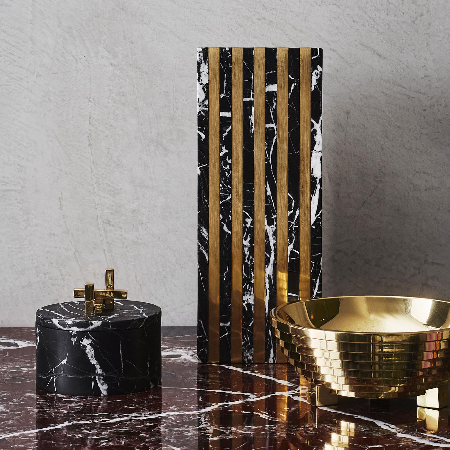 Purity of form and a flash of glamour. The round Metropolis box in Nero stone with its elegant polished brass handle serves as the perfect gift or keepsake. 

Dimensions: D 110 x 62 H mm
Materials: Nero marble, brass

Marble is a naturally