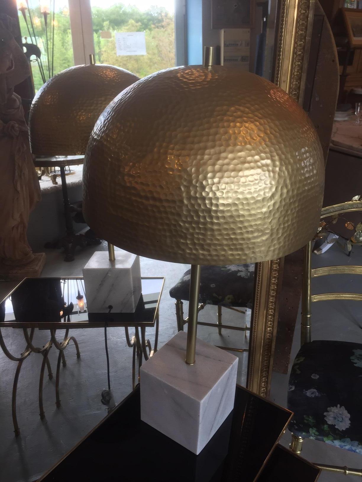 Beautiful contemporary marble and brass table lamp. 
White marble base and hammered brass shade. 
Two bulbs. 
Very nice quality.