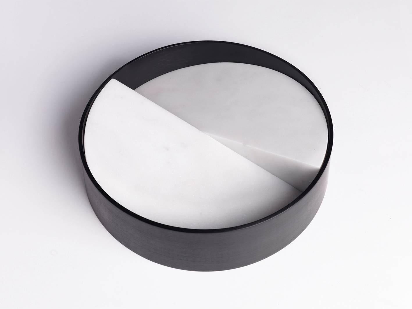 The let it slide bowl is made of two angled white Parthenon marble sections joined together by a contrasting anodised aluminium ring. The bowl has a strong architectural aesthetic, forming a stunning centrepiece.

Year: 2015.

Dimensions in cm: