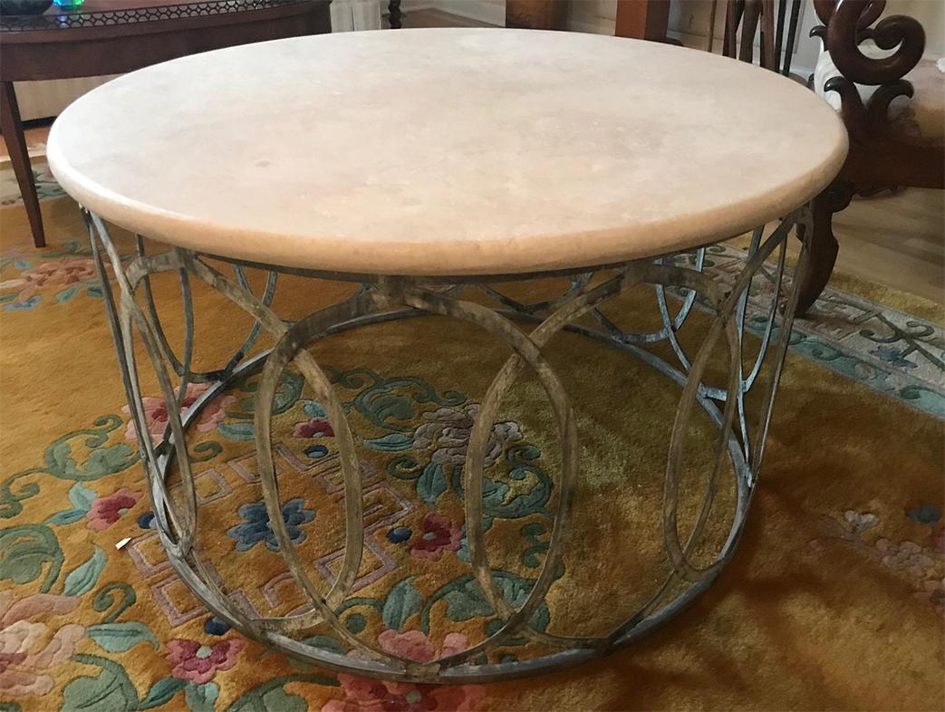 Vintage marble-top coffee table on a metal base. The marble is white and grey and the metal base is dark grey with a painted patina in shades of light grey. The top is removable.