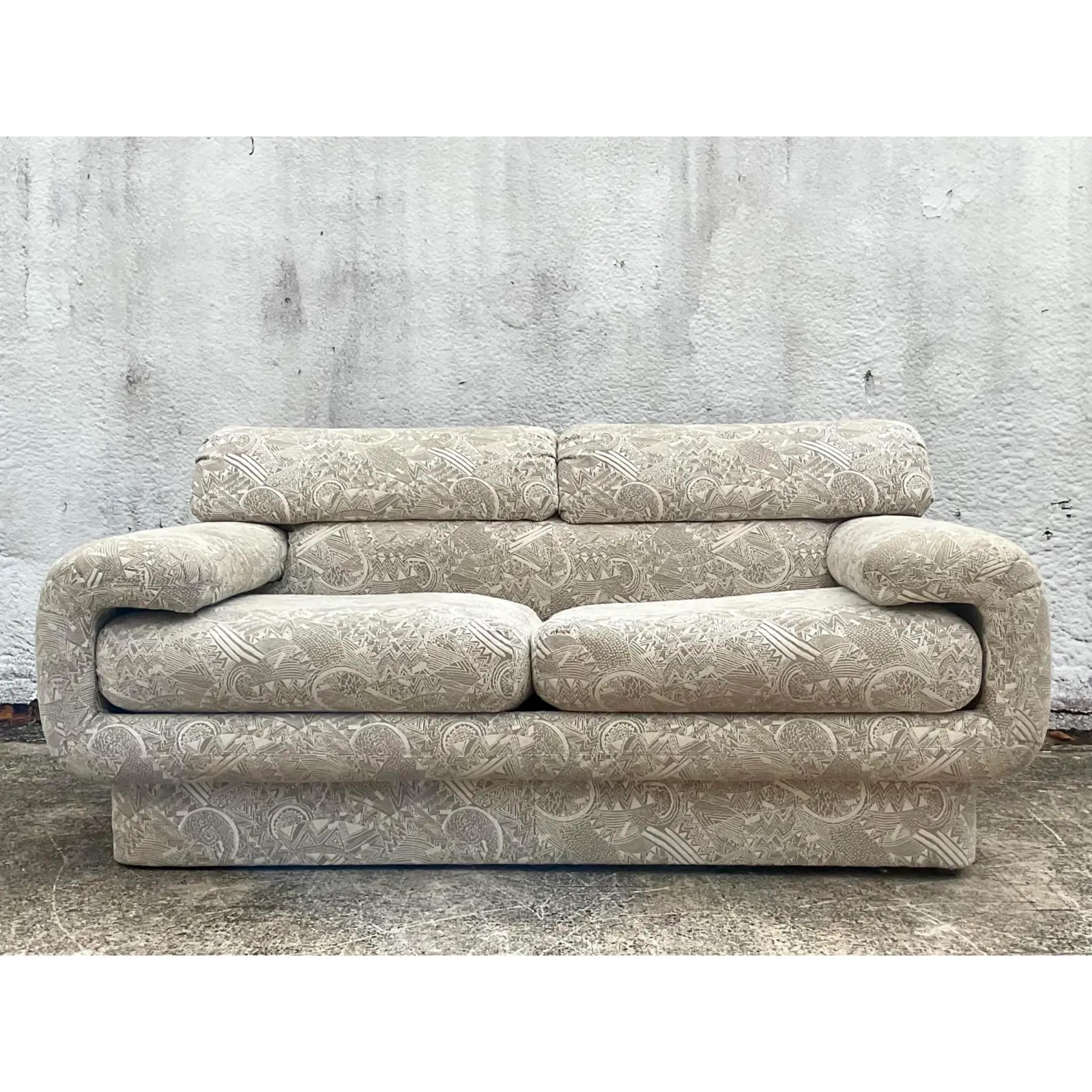 Incredible vintage Carson’s Gondola sofa. A chic futuristic design with wrap around arms. Done in a neutral jacquard in a modern graphic paisley design. Acquired from a Palm Beach estate.