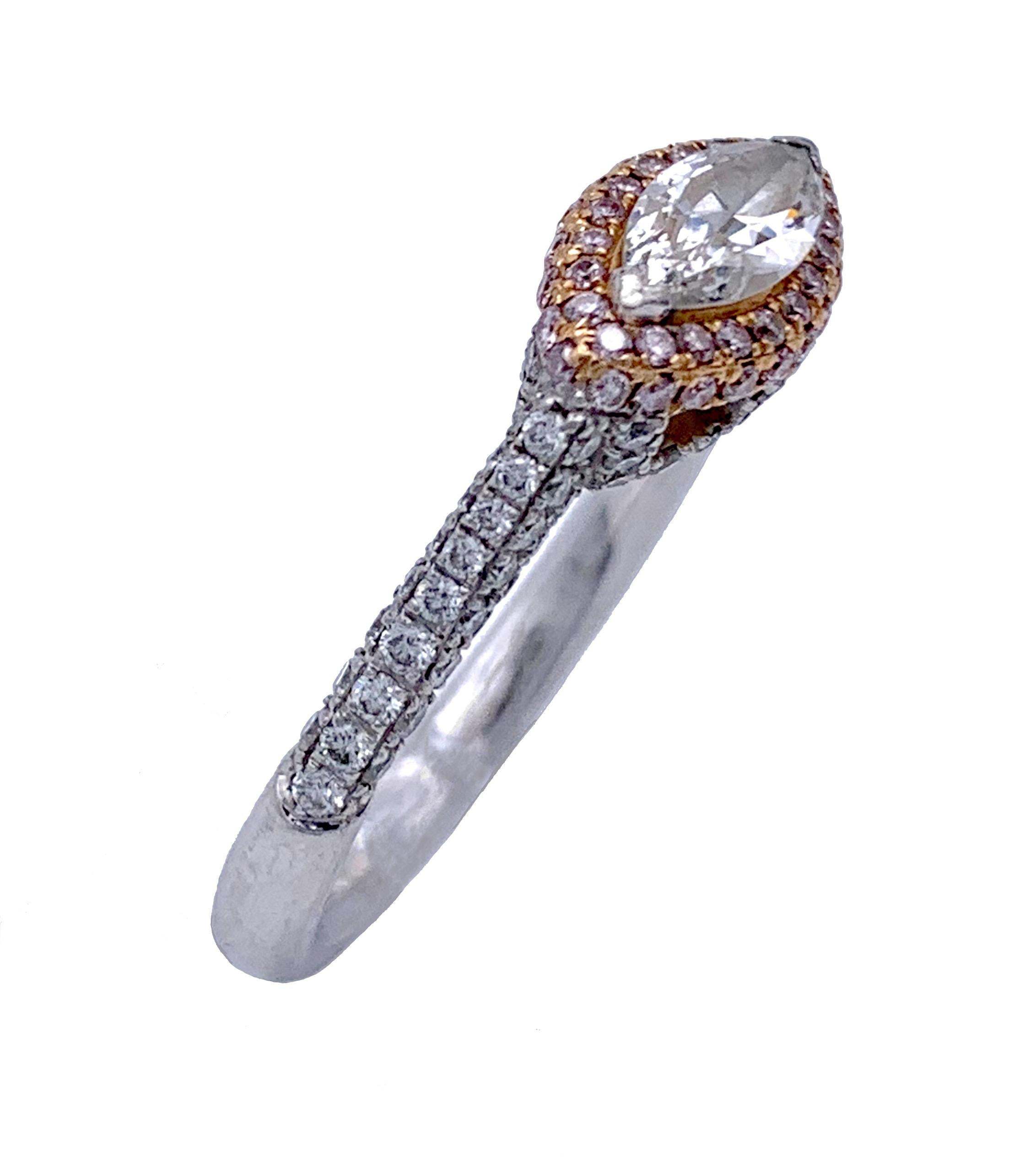 This elegant engagement ring features a marquise cut center stone with thw established weight of 0.5 carats surrounded by pink diamonds set in 14 karat yellow gold. The sides of the ring and the shoulders are also decorated with small diamonds.The