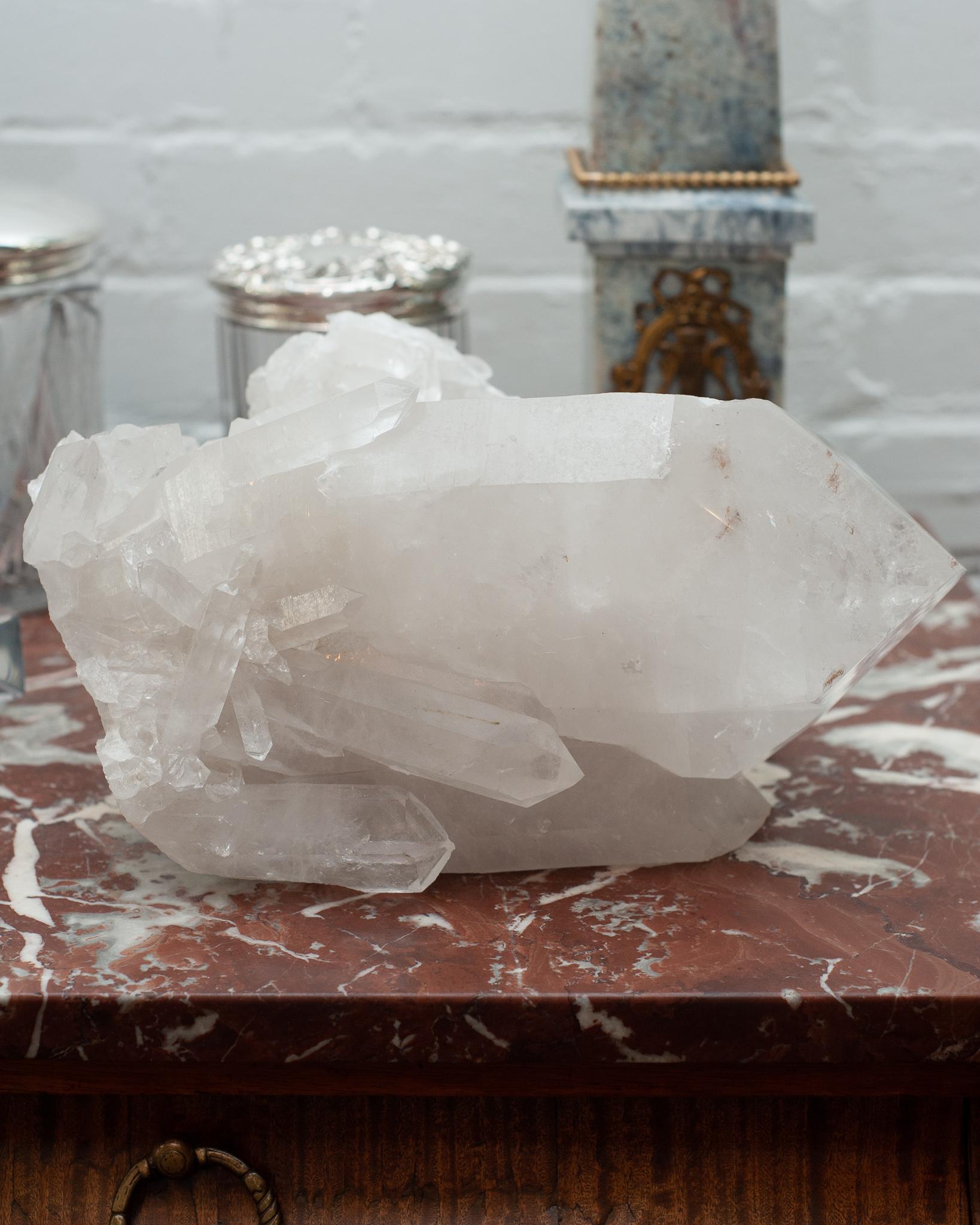 A massive contemporary rock crystal point cluster, weighing in over 18 pounds. Huge central crystal points are surrounded by smaller points in this one of a kind natural specimen. Rock crystal has long been used in decoration and many ornate pieces