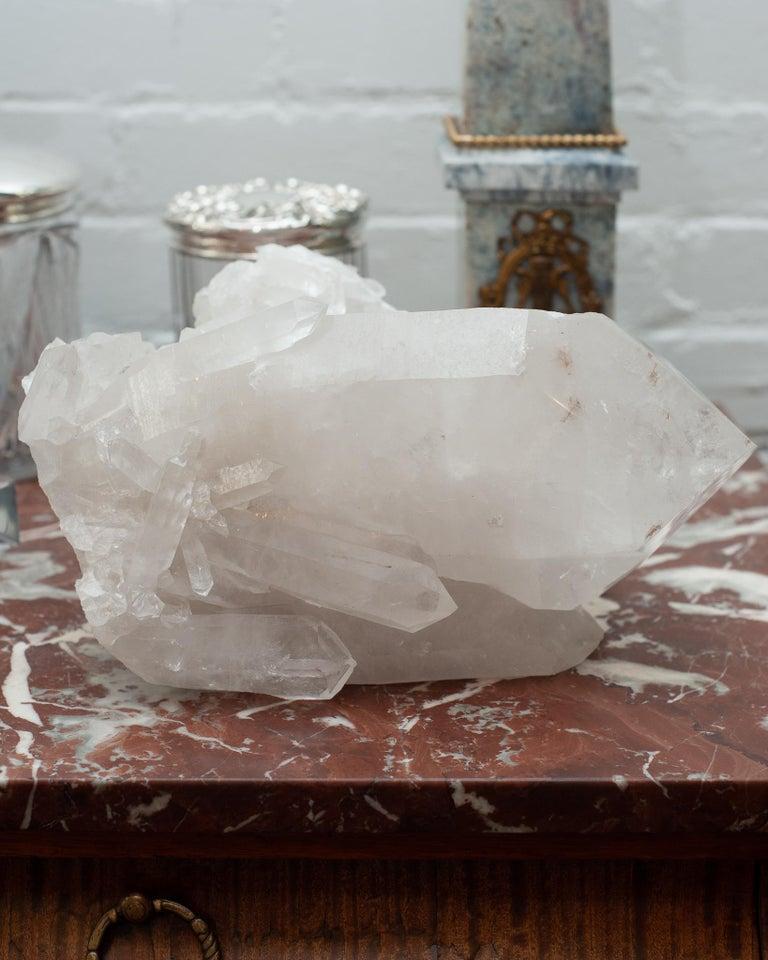 A massive contemporary rock crystal point cluster. Huge central crystal points are surrounded by smaller points in this one of a kind natural specimen. Rock crystal has long been used in decoration and many ornate pieces are exhibited in museums
