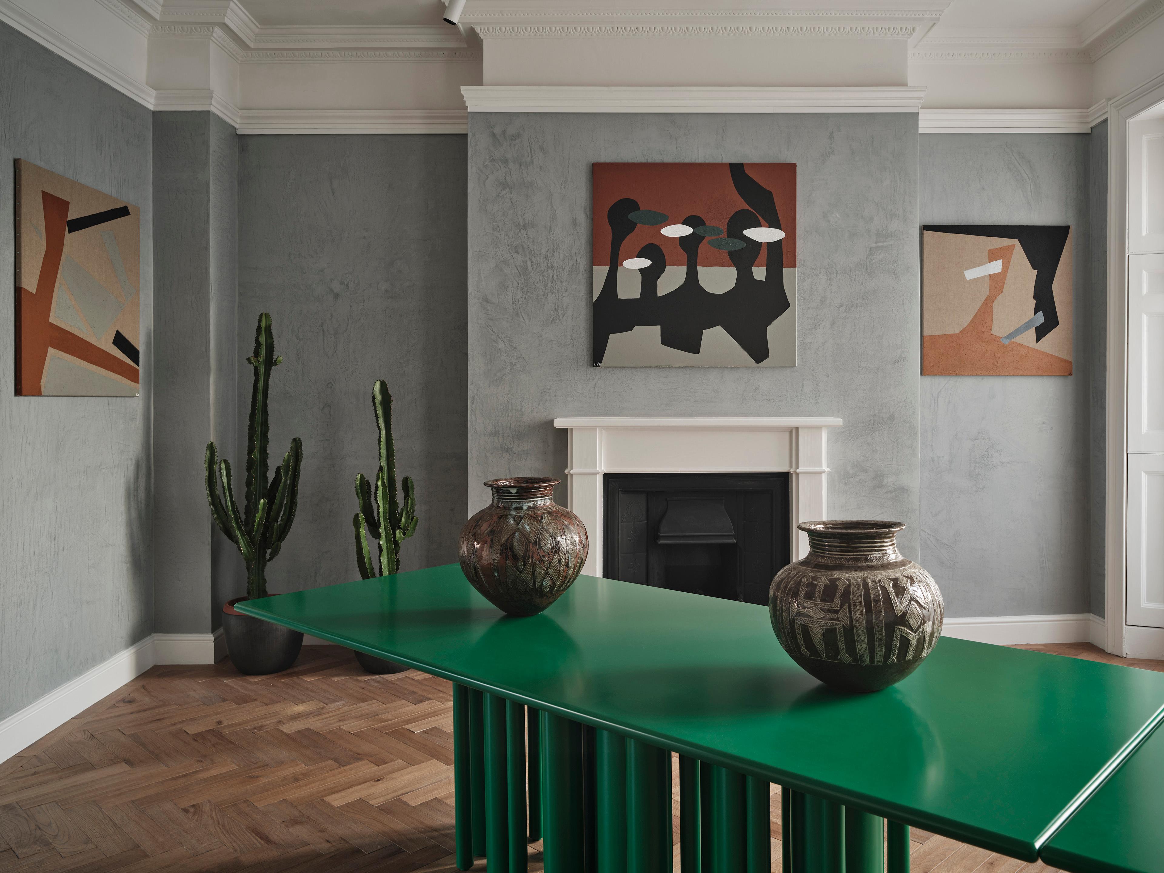 The Townhaus green contemporary table for SoShiro by Interni Design Studio makes for an eye-catching sculptural centerpiece for any dining room as well as for an office or boardroom. 

The lush green matte lacquer transforms the surface of the