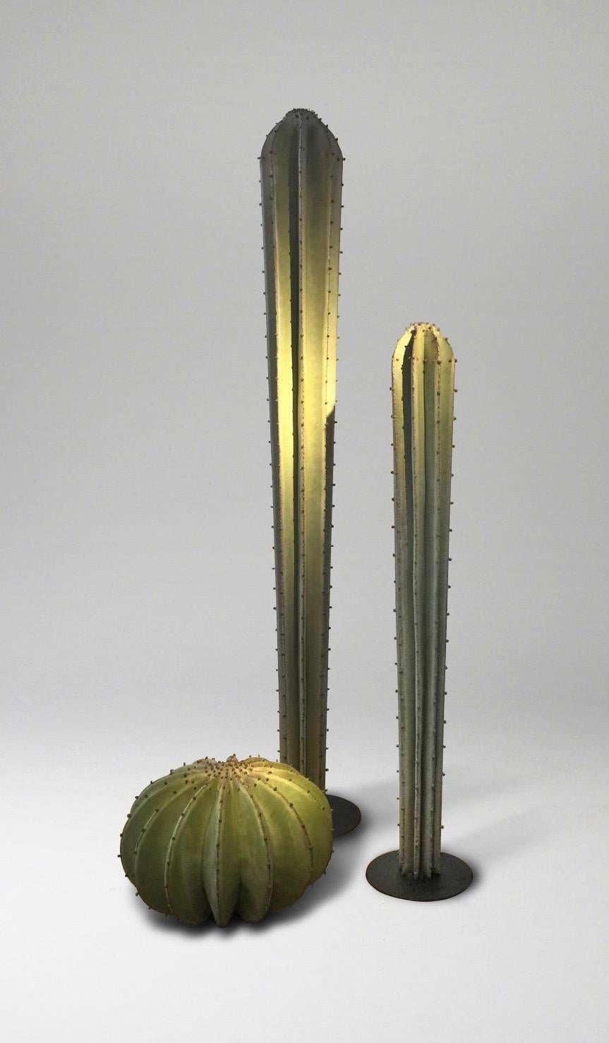 A group of three handwrought metal 'cacti', patinated in matte shaded green, for interior space or outdoor terrace or garden. Each is an independent sculpture so can be moved and arranged as desired.
Measures: Taller cactus height 200, diameter 25