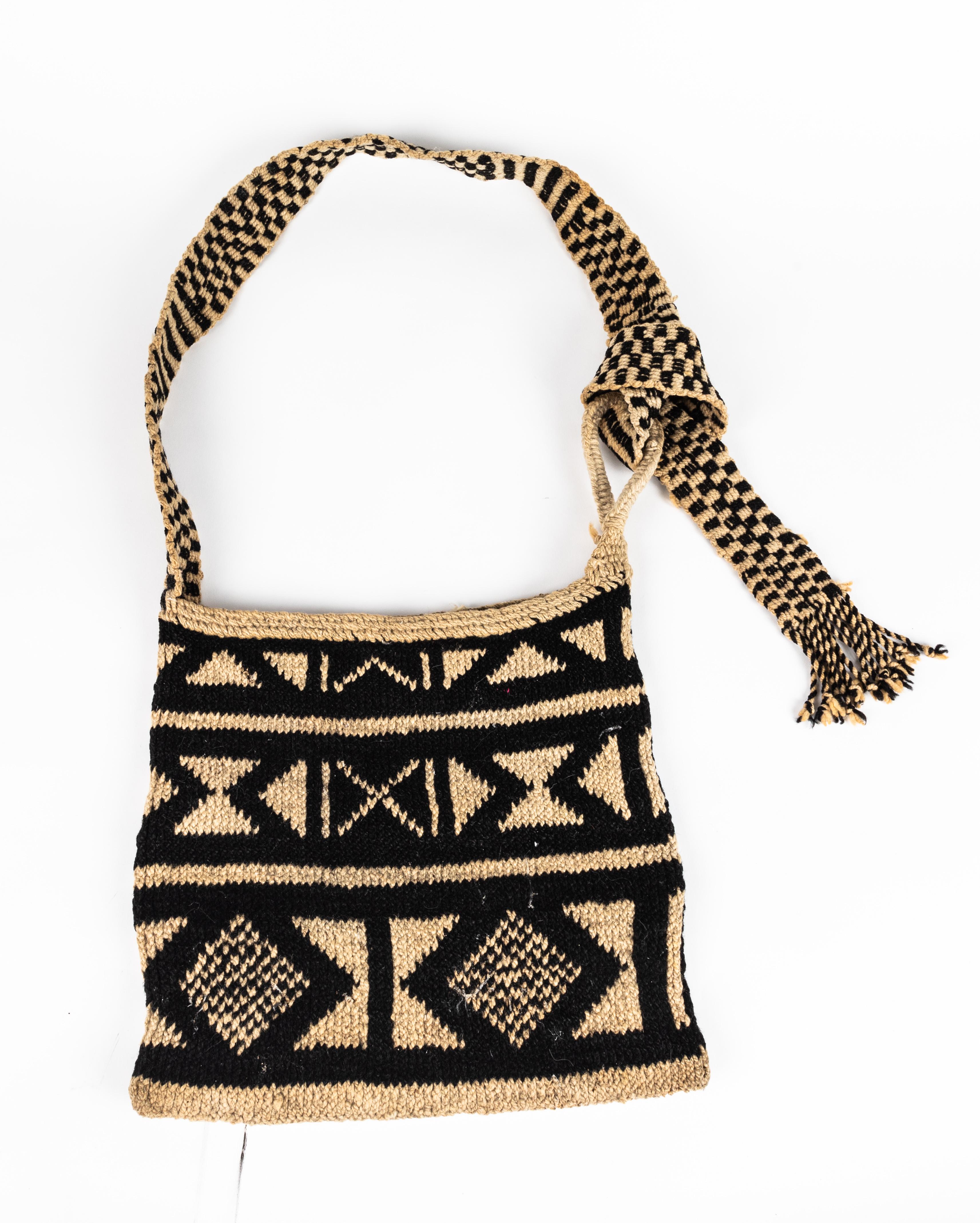 Contemporary Mexican handwoven decorative bag in black and natural pattern. Strap has a 24