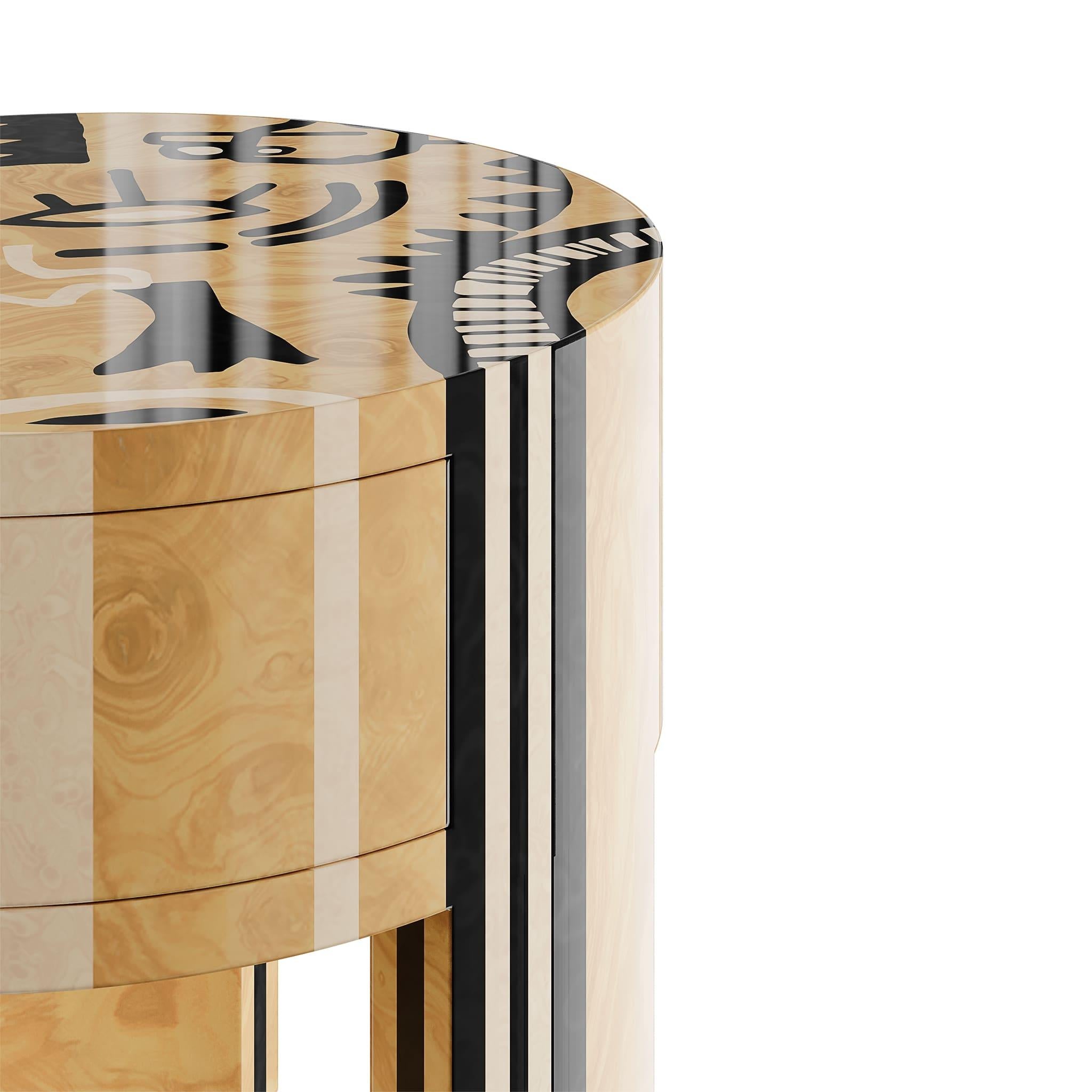 Folk Bedside Table adds an unmistakable design style to your home. This modern round bedside is a bold furniture piece that will uplift the look of any contemporary bedroom decor.
The three-legged bedside table features modern marquetry details, a