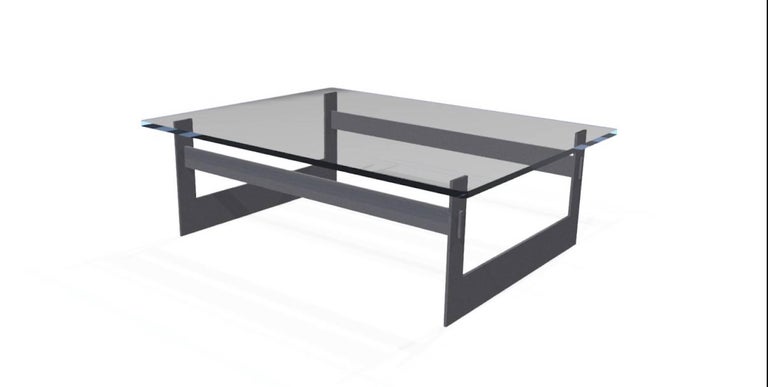The UMA Coffee Table, an original design offered exclusively by Vermontica, is a contemporary minimalist blackened steel and glass coffee table designed and produced in Vermont by Scott Gordon. The 3/8