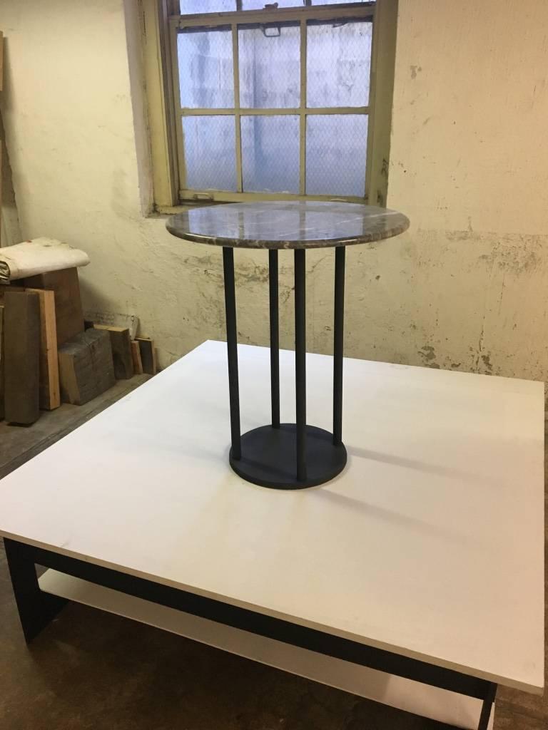 The Maria Table, an original design offered exclusively by Vermontica, is a contemporary minimalist blackened steel and marble occasional table designed and produced in Vermont by Scott Gordon. It features a steel base with 4 pillars supporting a